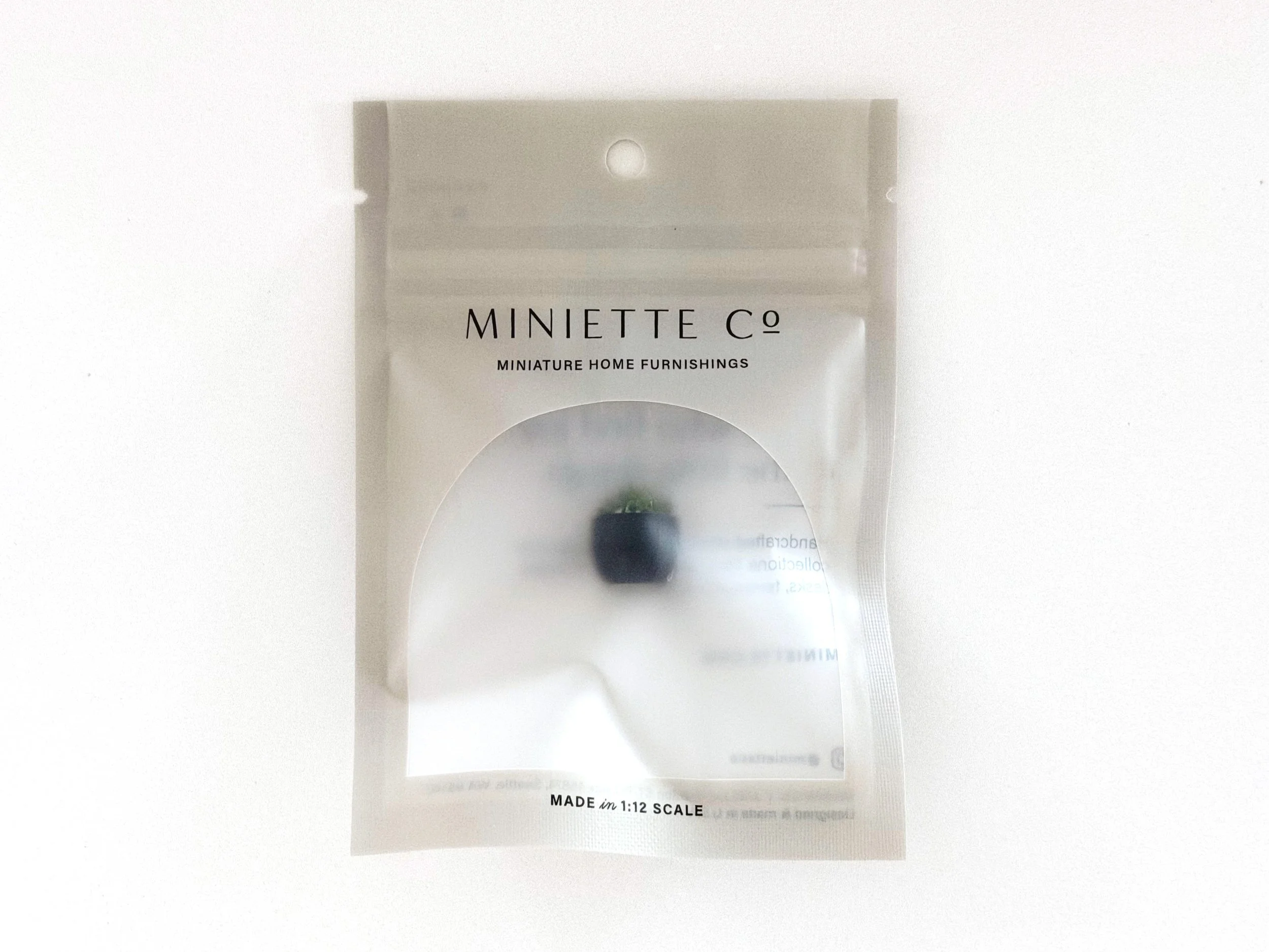 Bright green faux moss in black miniature bowl