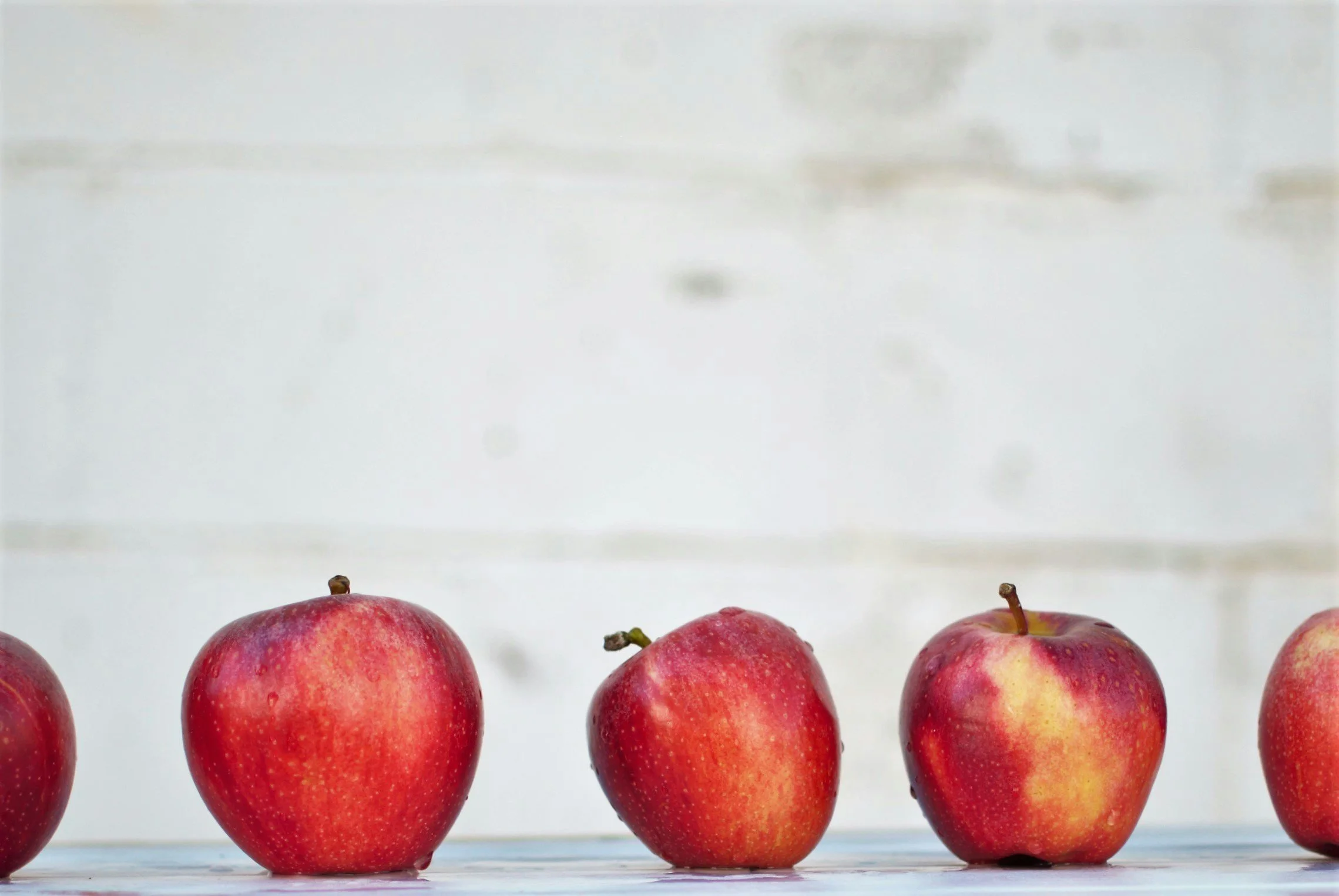 line of freshly picked and rinsed red apples.
