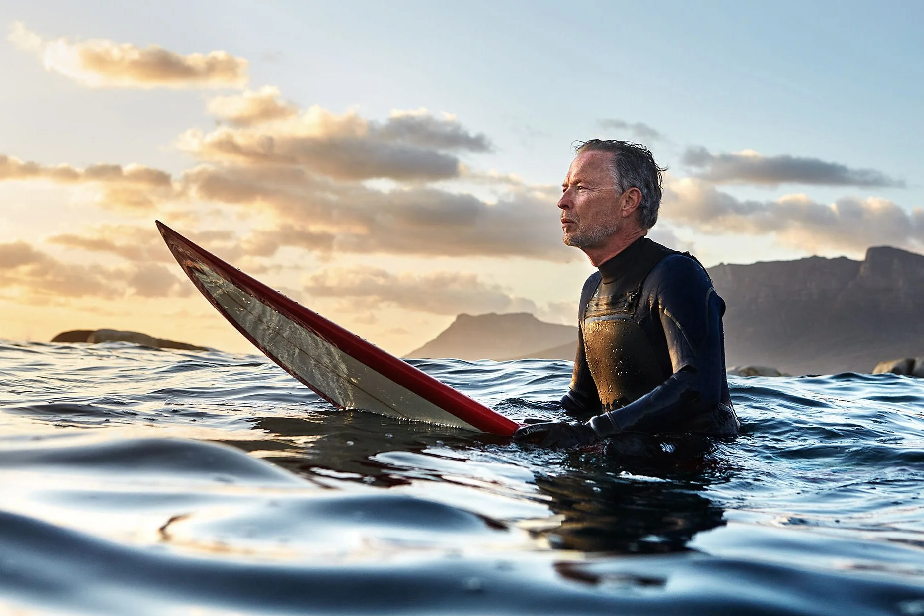 Active lifestyle photography senior man surfing ocean sunset adventure travel