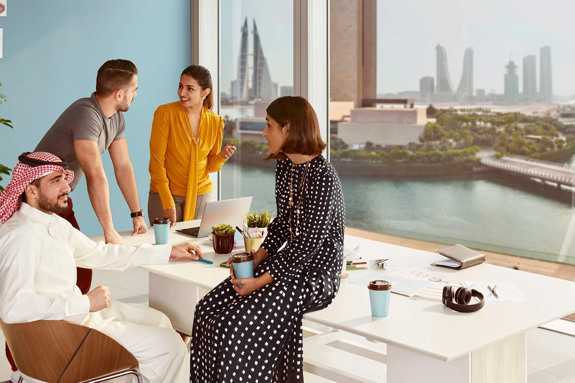 Professionals engaged in a business meeting in a modern office, with a panoramic cityscape visible through large windows in the background.