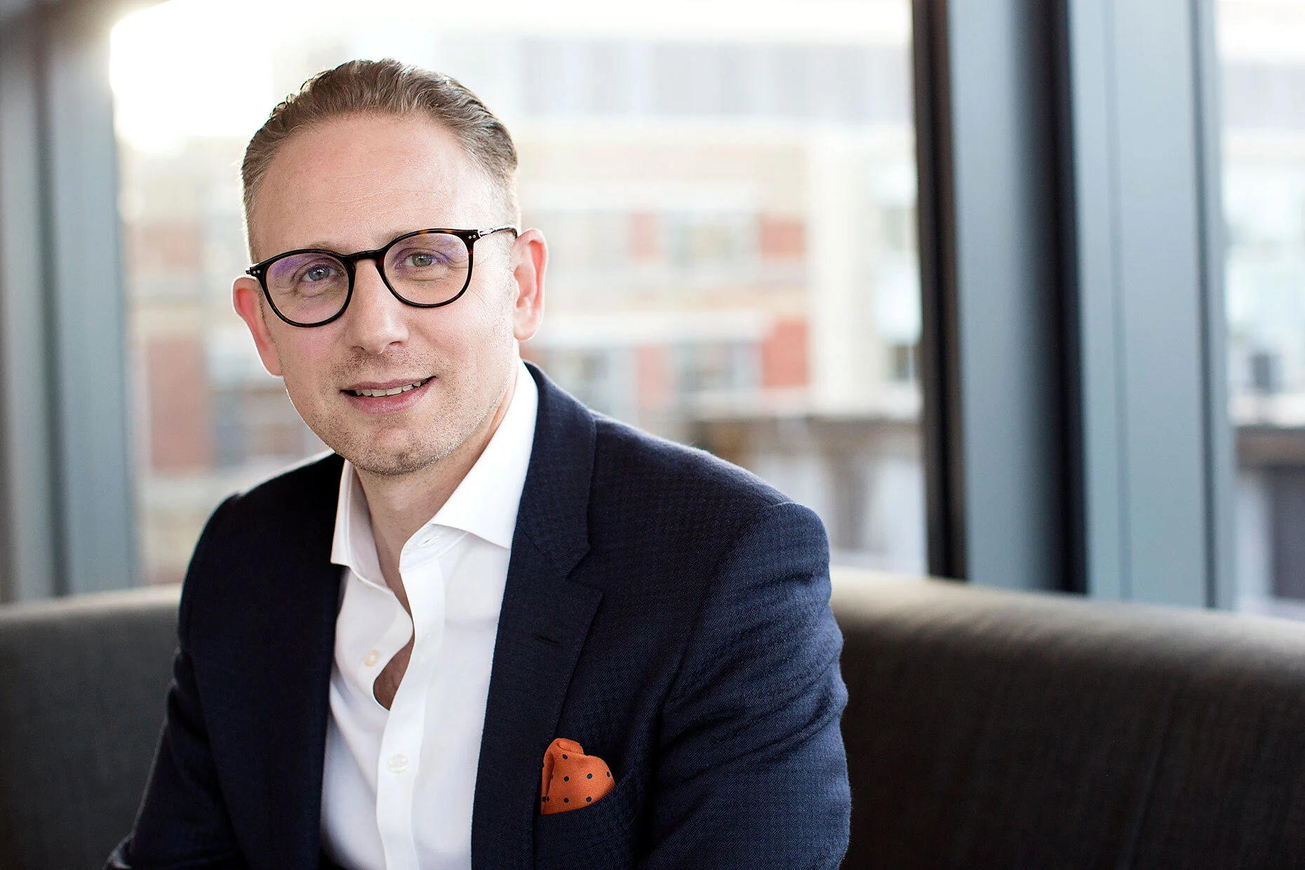 Portrait of a businessman in a modern office, reflecting confidence, professionalism, and executive presence.