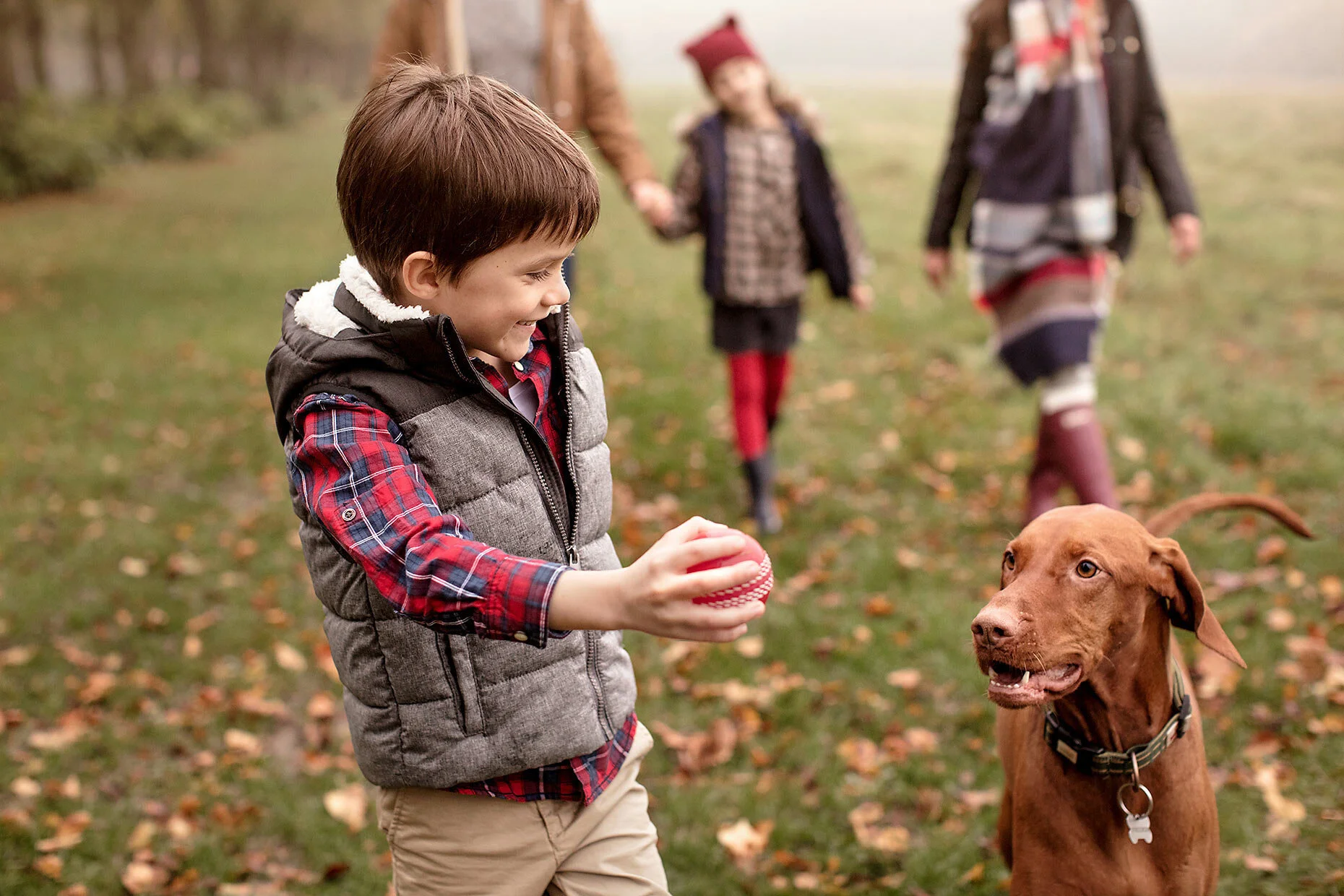 Family lifestyle photography boy playing with dog park outdoor activity campaign