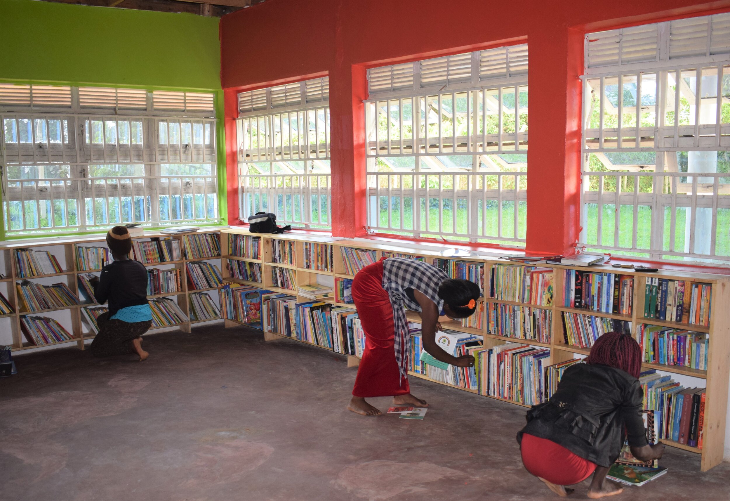 Girls helping to stack books into the shelves.jpg