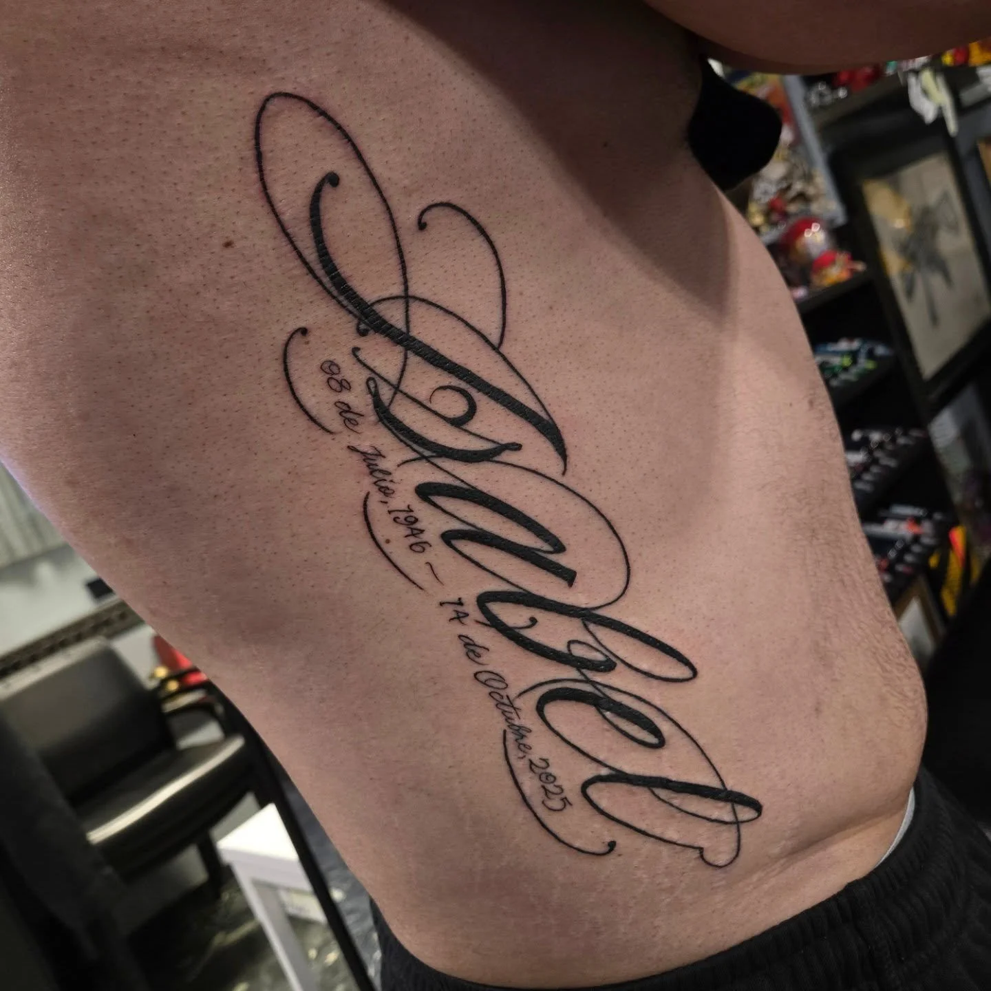 "Isabel" down the ribs. I would love to do some more script in this style. Dm me or email me at Aaron@diaztattoos.com to book an appointment. I have some openings left for this month and booking January.