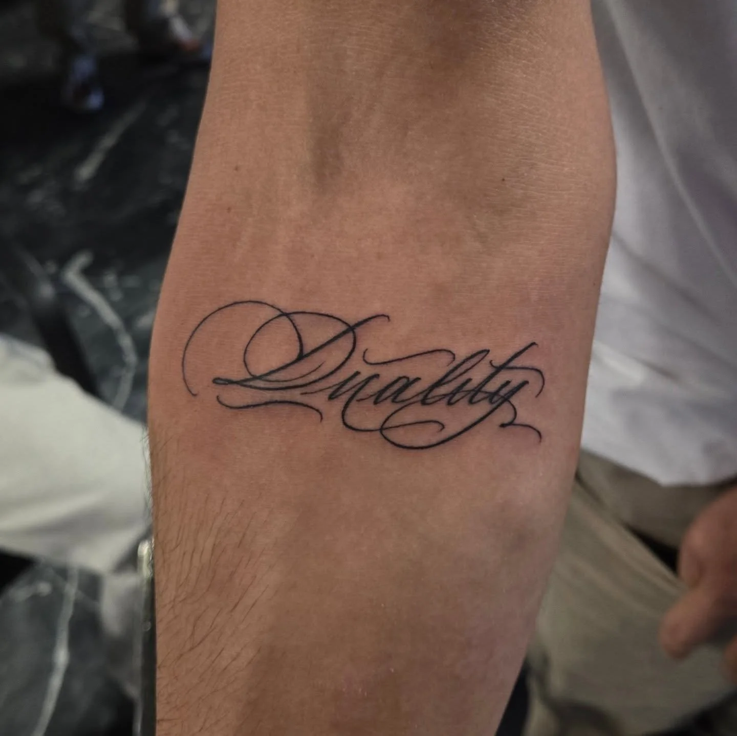 "Duality" in a fancy script. Id love to do some more tattoos in this script style! I have some openings left for this month and booking Feb. Dm me here or email me at Aaron@diaztattoos.com to book an appointment