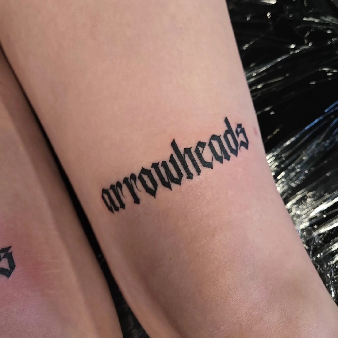 "Arrowheads" small clean calligraphy. 
Always booking appointments, dm me here or email me at Aaron@diaztattoos.com
