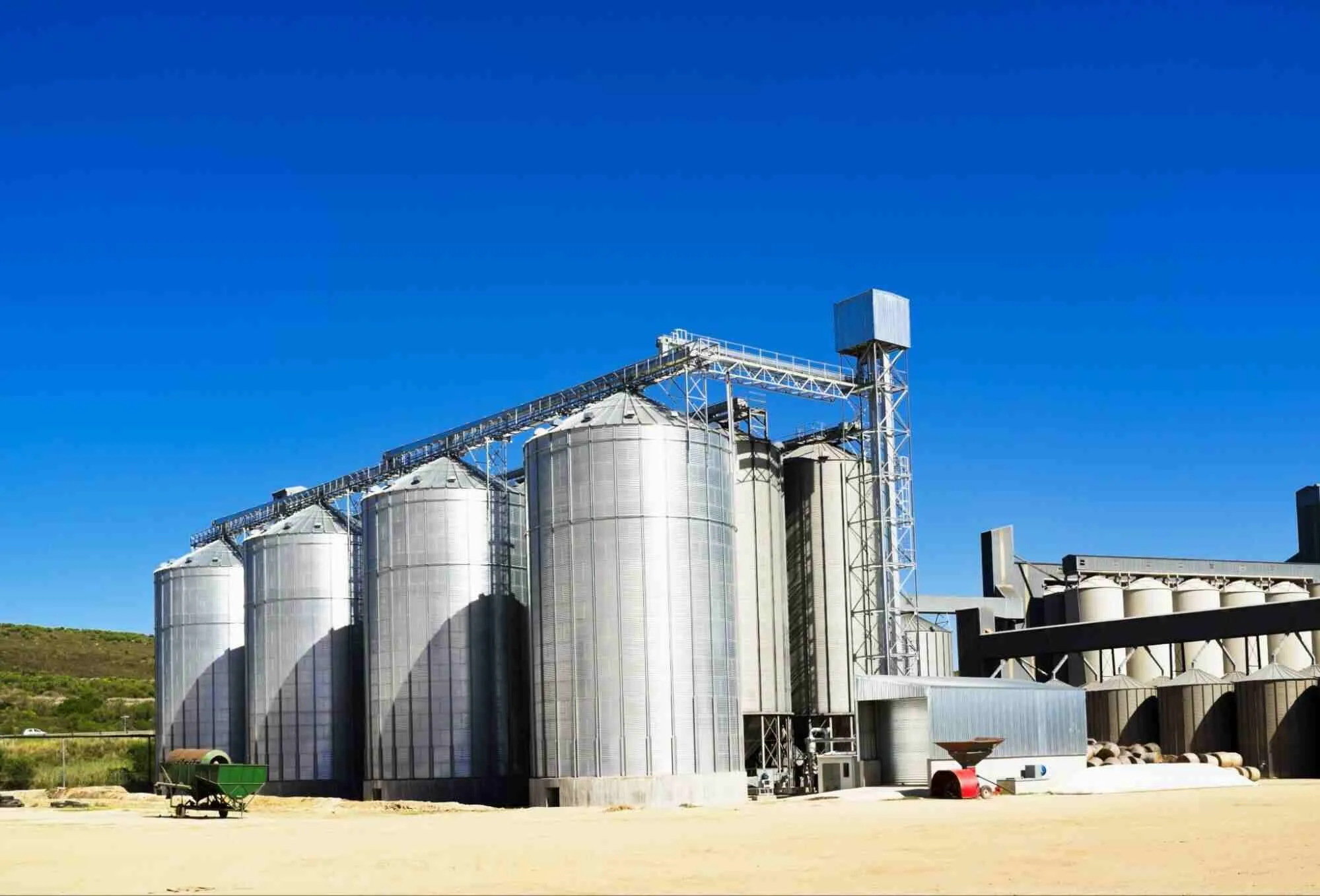 Grain handling ROI represented by modern grain storage bins connected with an integrated conveyor and handling system.