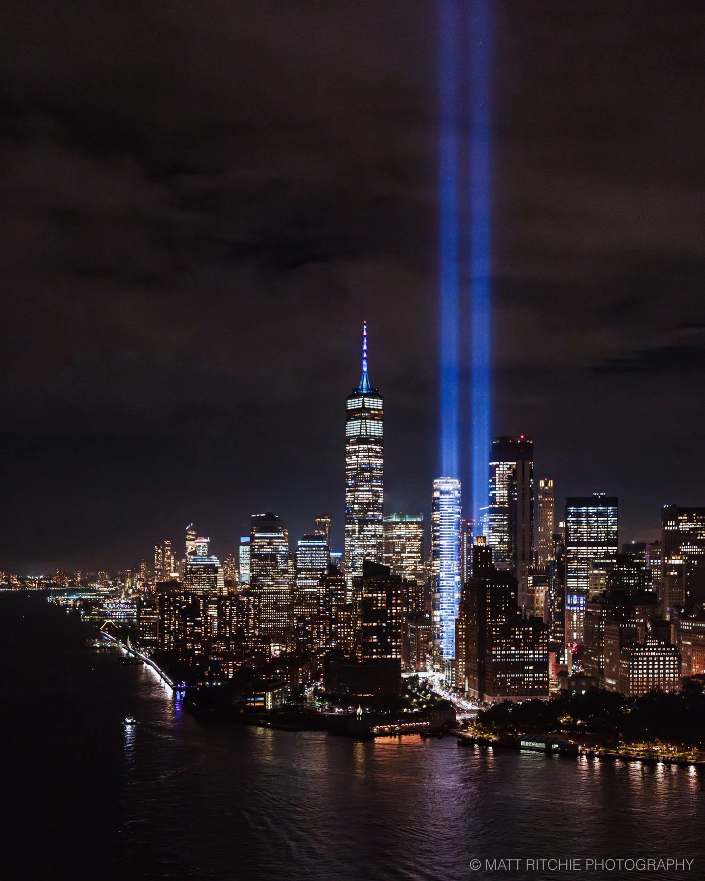 Night aerial photograph of the Tribute in Light over New York City, taken from a FlyNYON doors-off helicopter.