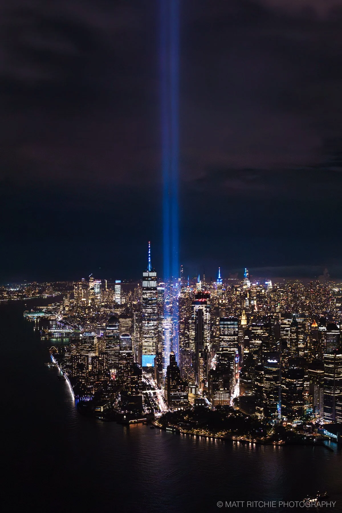 Tribute in Light beams shining into the night sky over Lower Manhattan, photographed from a FlyNYON helicopter.