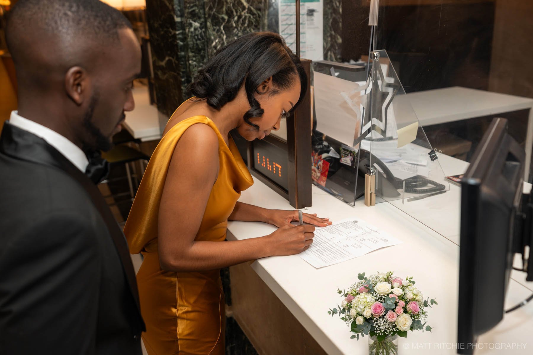 Couple at Manhattan City Hall Signing Marriage Document