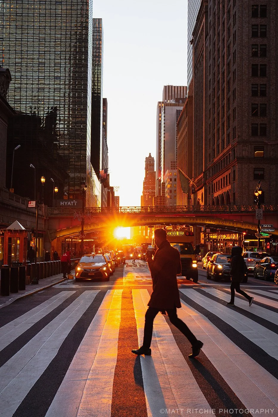 Reverse Manhattanhenge in New York City with the sun rising between Manhattan buildings