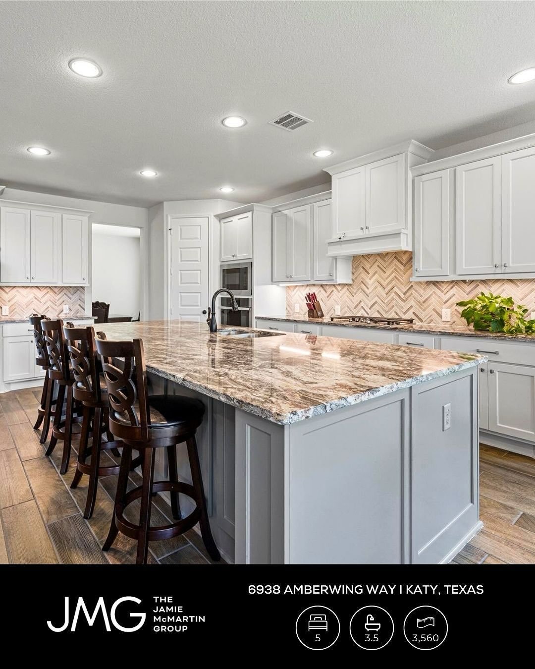 Morning light pours through soaring windows, reflecting off the lake as the home awakens with peaceful, private views.

The heart of the home hums with life, gourmet kitchen sizzling, laughter drifting from the open living room and game room above.

