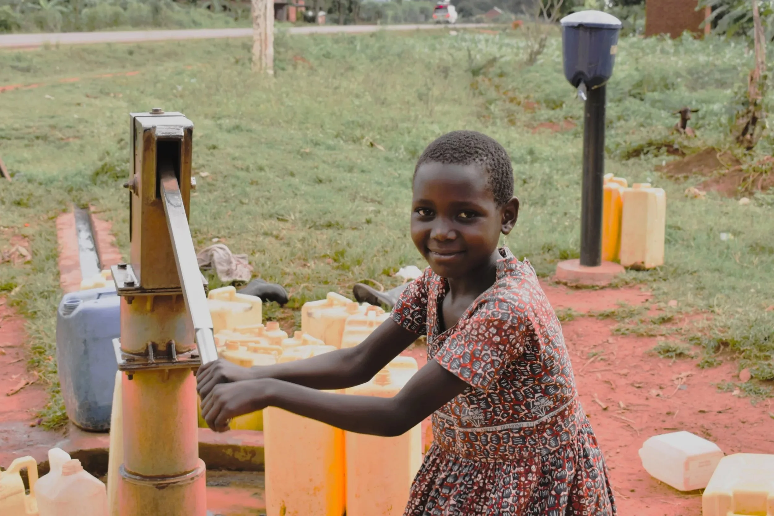 Child at water pump.jpeg