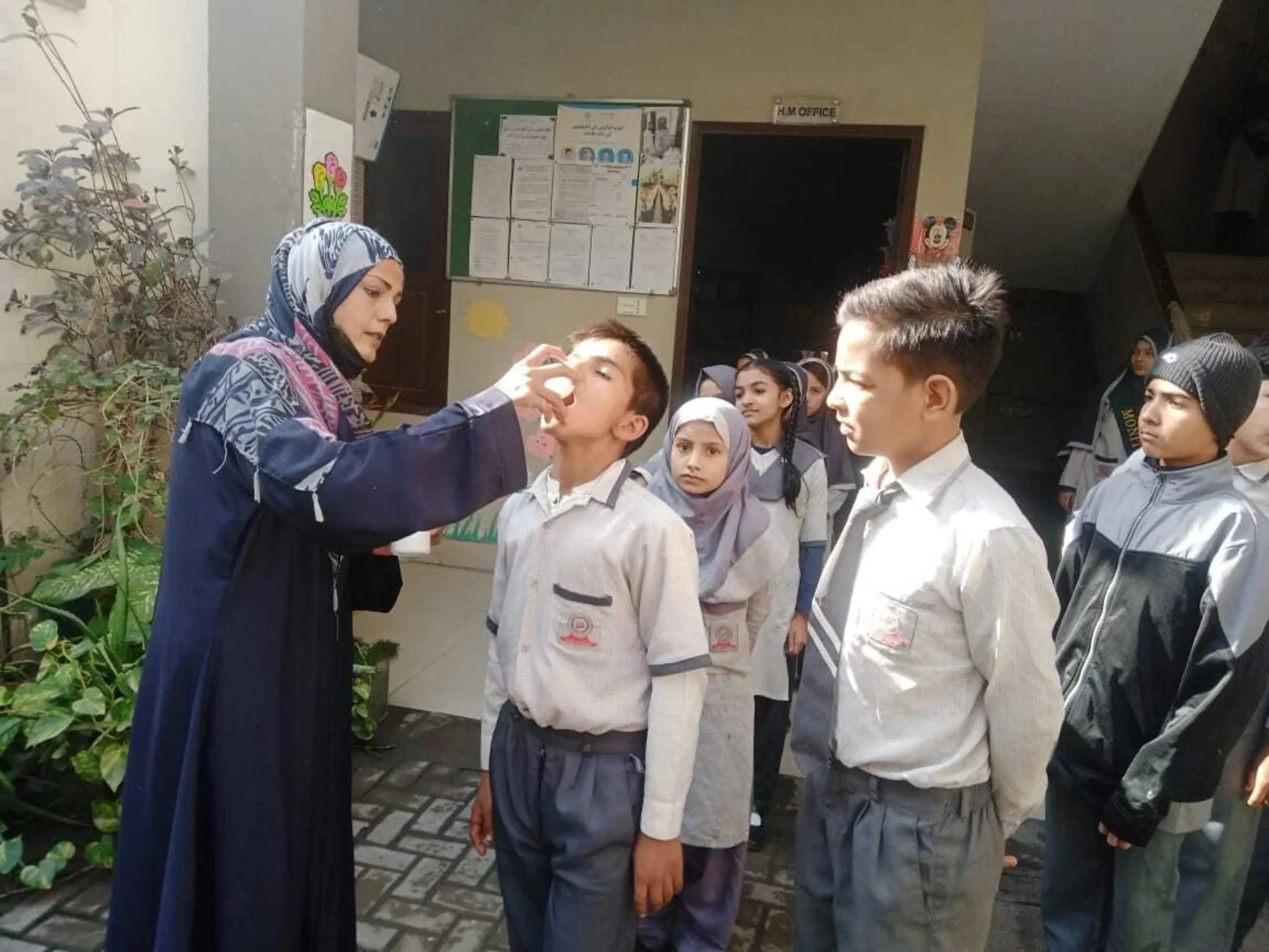 Children in Karachi, Pakistan receiving deworming treatments.