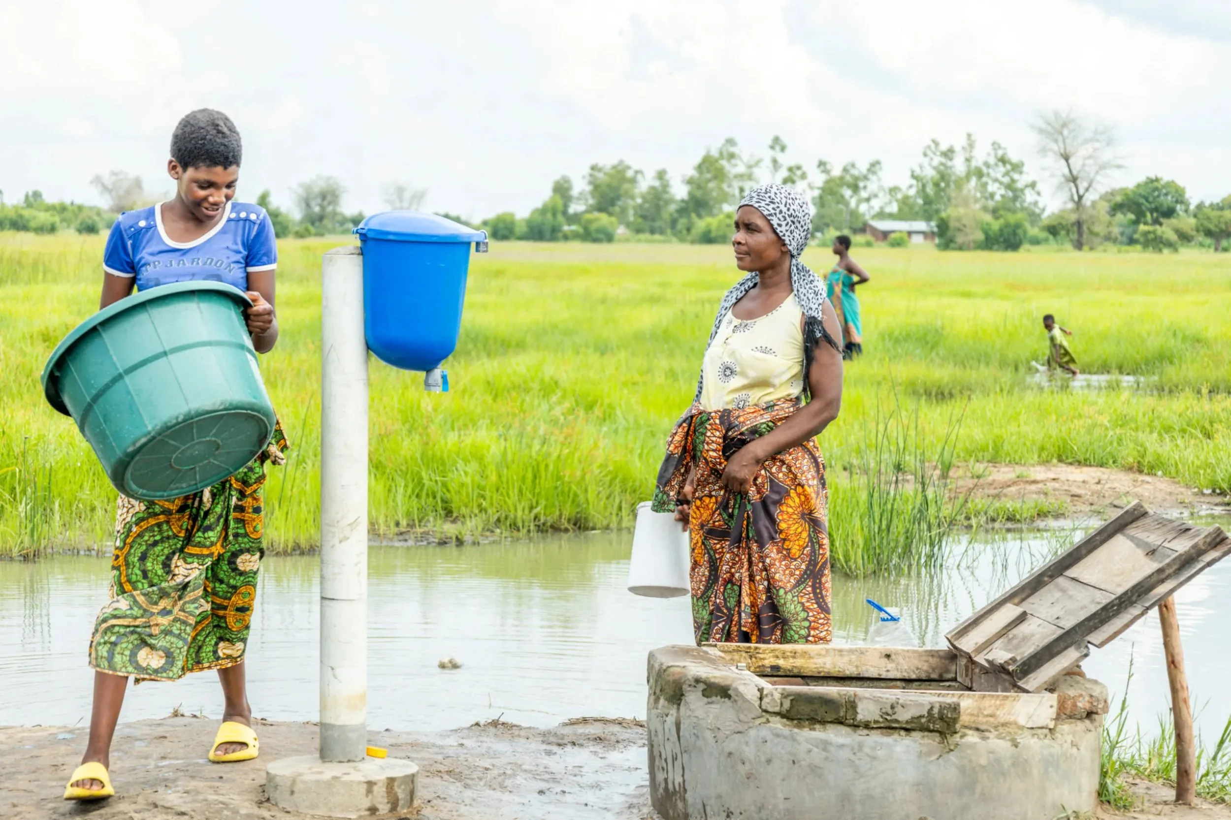 People with Evidence Action chlorine dispenser amidst flooding Malawi.jpeg