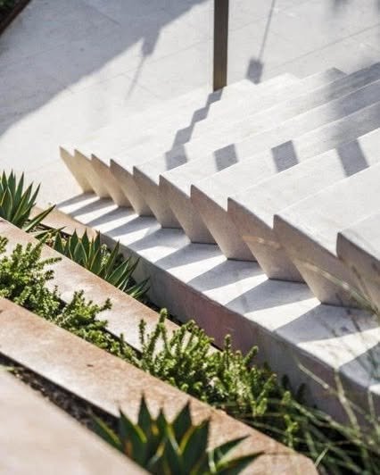 The new stair integration was a key design element, seamlessly linking the entertaining areas over sloping terraces. 

The clean lines of the off-form concrete staircase serve to create a quiet yet impactful architectural feature within the home. Pal