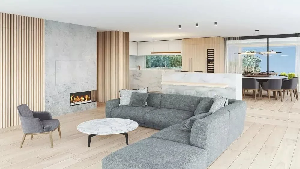 An open-plan layout brings the living area, kitchen and dining into a clear sequence, organised through placement and material while maintaining a sense of continuity between each space.

A stone fireplace anchors the space, paired with vertical timb