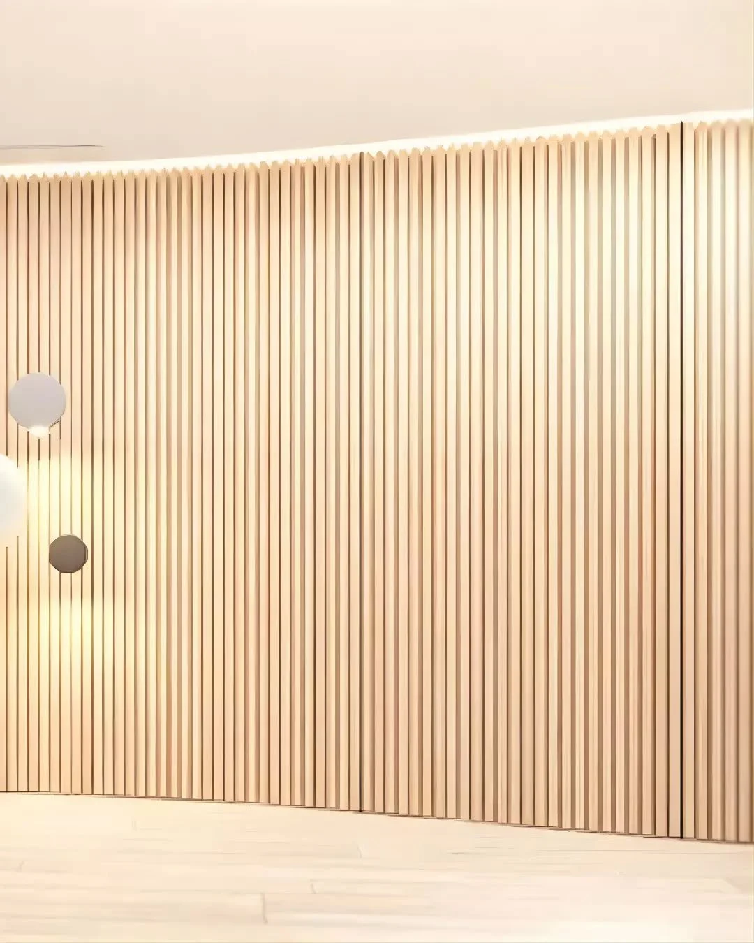 The repetition of vertical timber elements establishes a subtle pattern while softening the overall geometry. A concealed door is integrated within the wall, maintaining the continuity of the surface while providing access to a hidden room. Lighting 