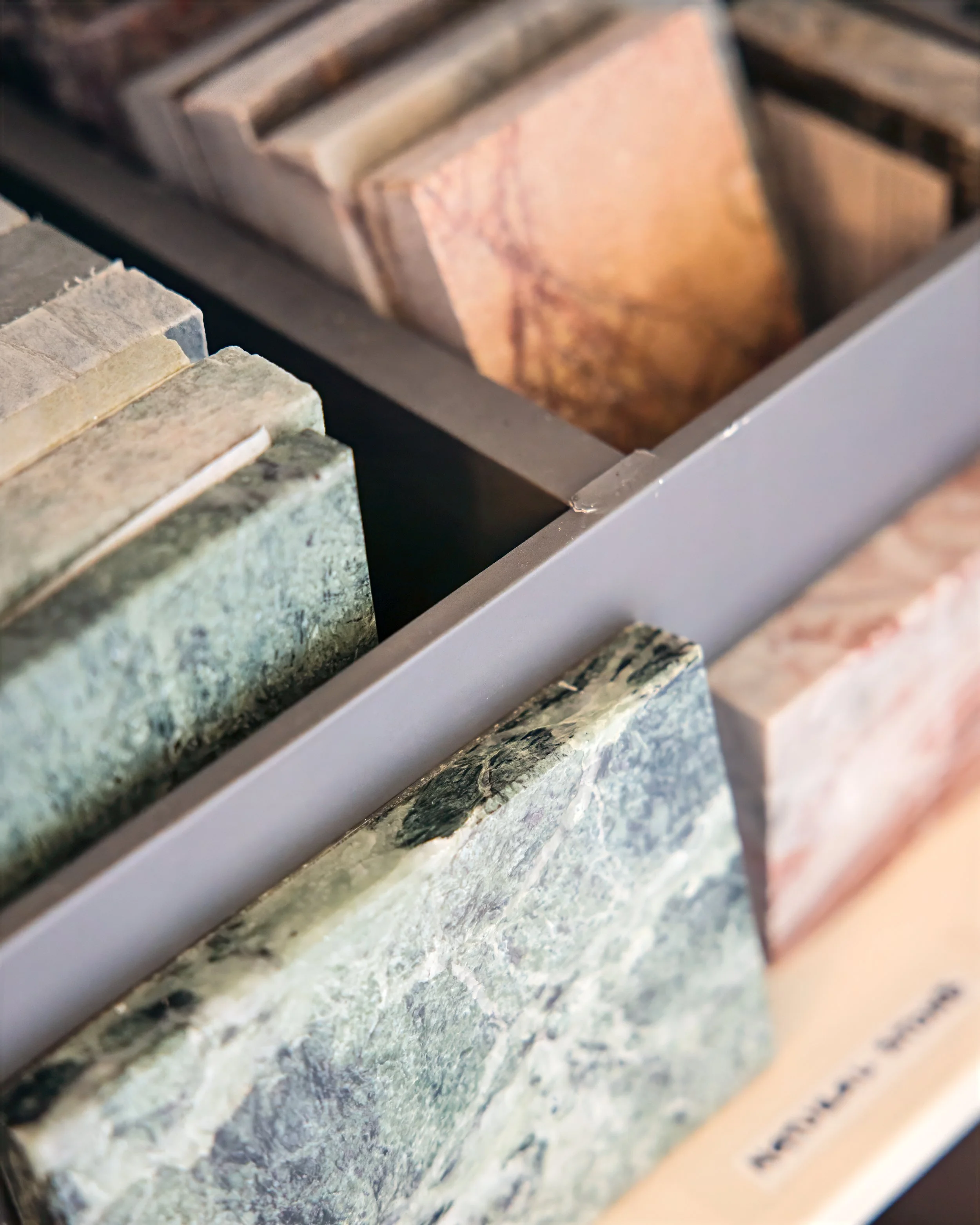 Close-up of assorted stone samples on display in the office