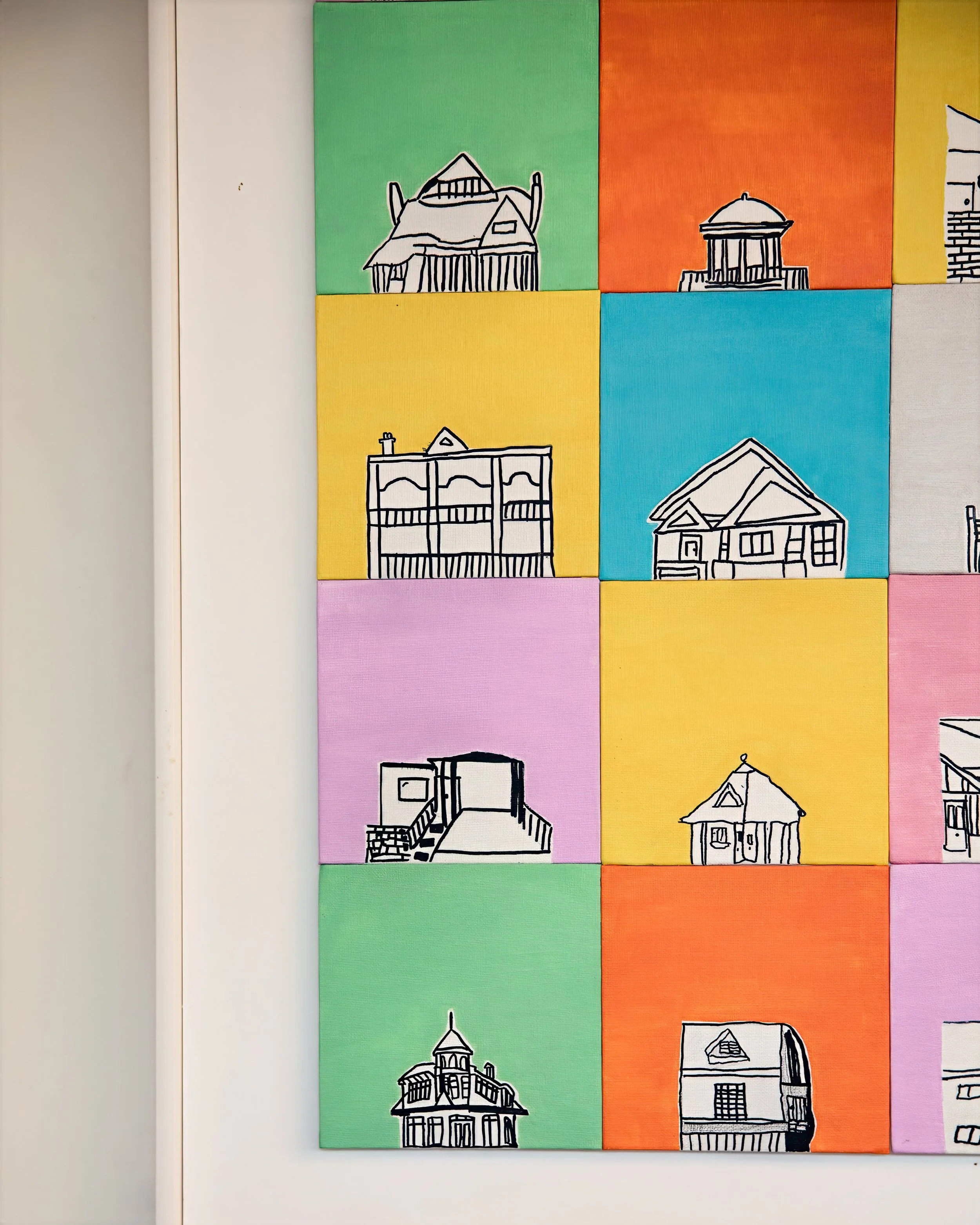 Colorful artwork featuring illustrations of various house and building outlines on bright colored squares.