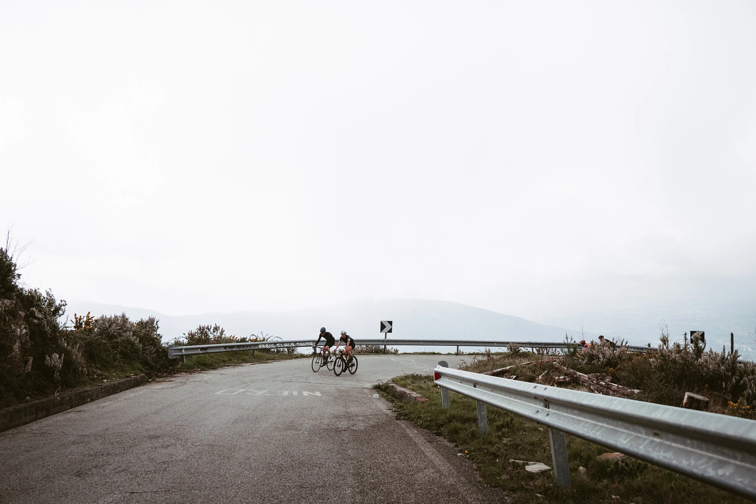 One of the side of the Monte Serra with two cyclists climbing it as part of Monti Pisani Asimismo's bike tour