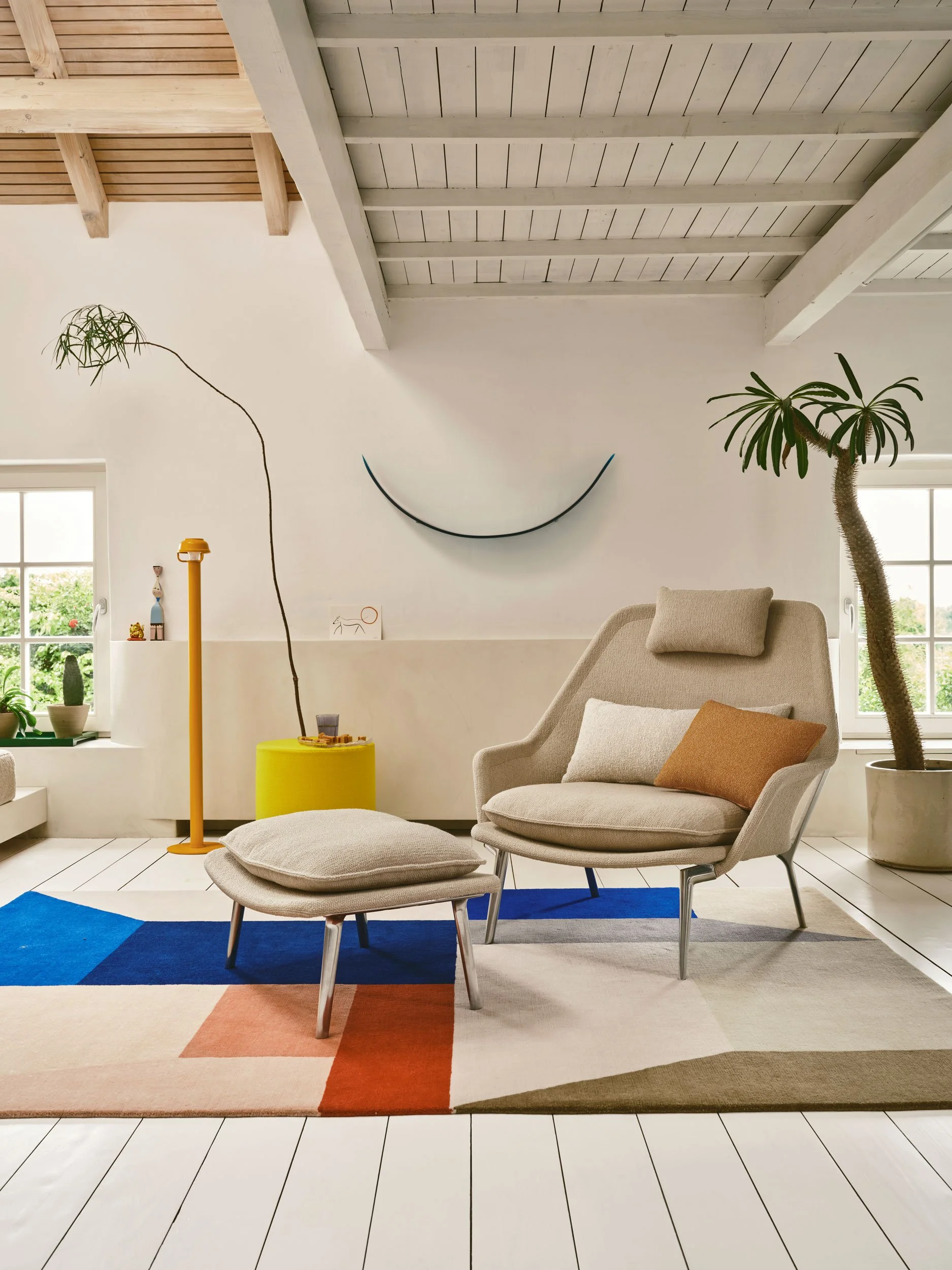 Der Künstler Lukas Cober und die Ärztin Vera Köller wohnen in Maastricht in einem ehemaligen Bergarbeiterhaus. Slow Sofa auf farbigem Teppich, Palme daneben