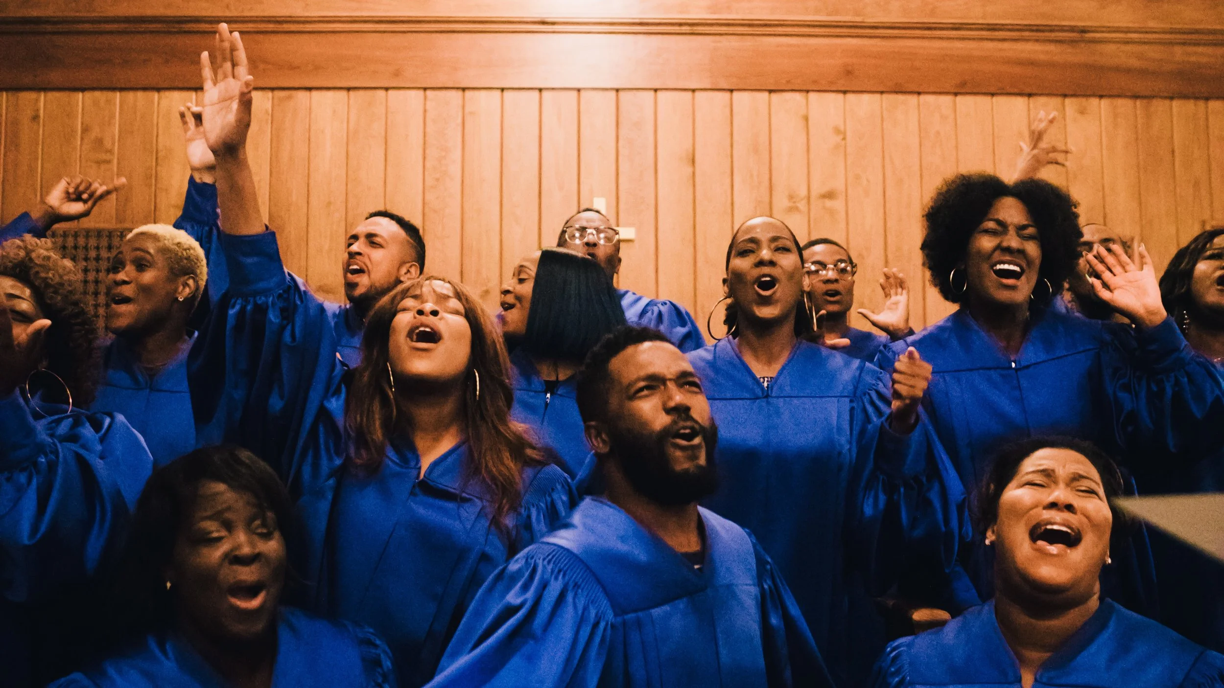 A group of people in blue robes singing together inside a church, creating a harmonious atmosphere of worship for Hillsong's "This Is For Everone" promotional video.