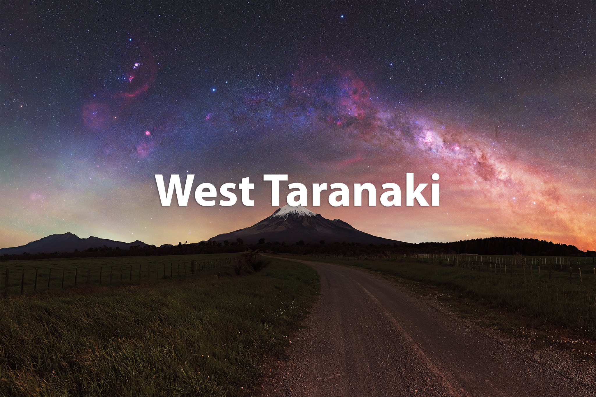 A nighttime landscape featuring a mountain with a snow-capped peak under a colorful, star-filled sky with the Milky Way galaxy visible. The foreground shows a dirt road winding through grassy fields, labeled 'West Taranaki' in white text.