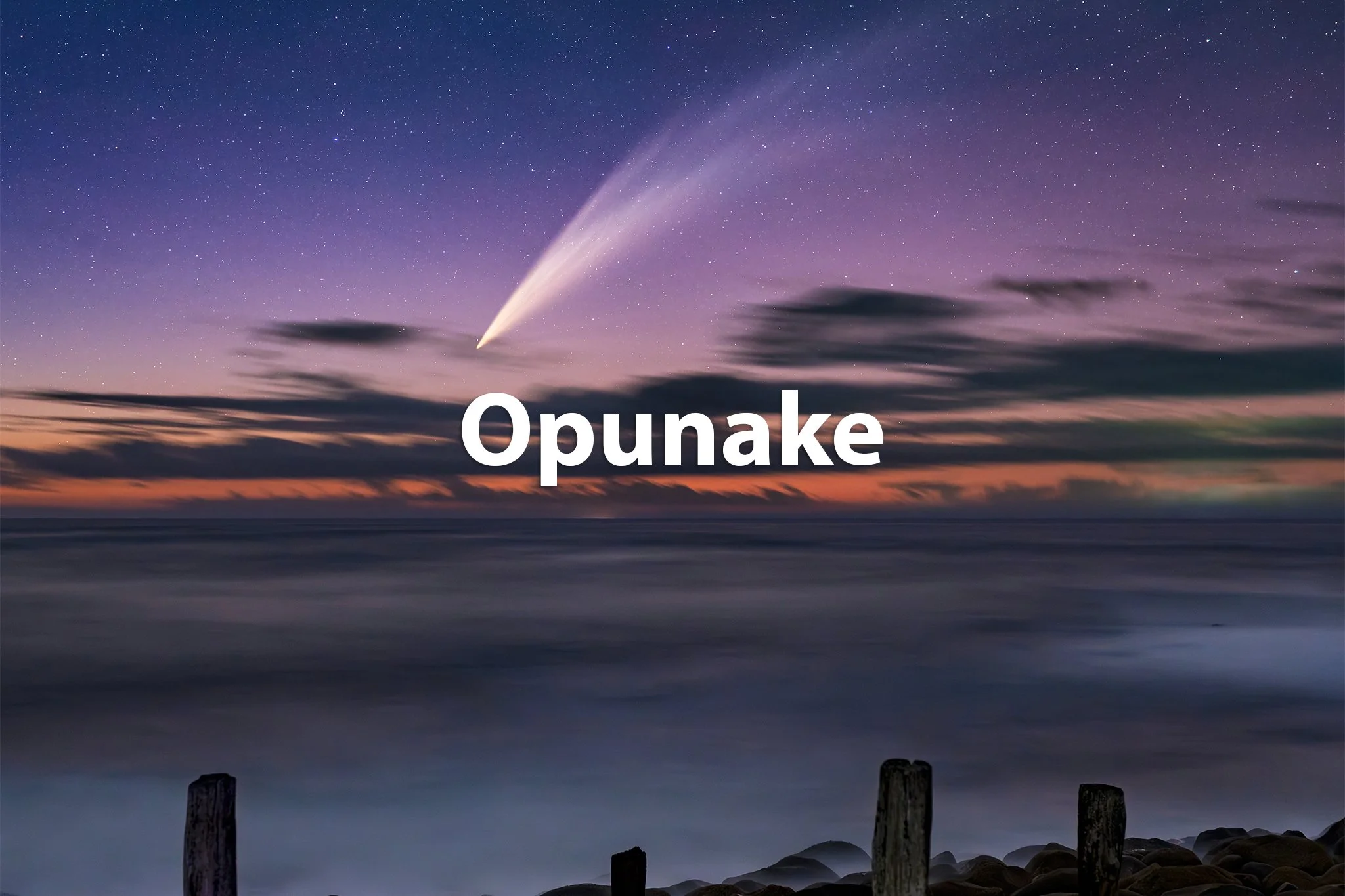 A night sky over the ocean with a comet, stars, clouds, and the word 'Opunake' in the center.