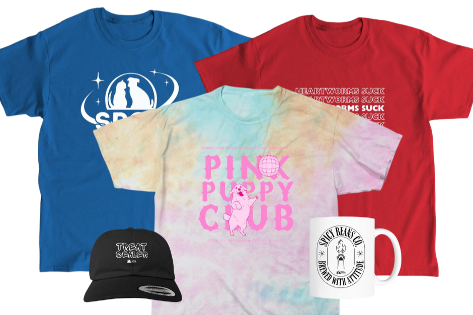 A collection of apparel and accessories including three graphic t-shirts, a black cap, and a white mug. The t-shirts are in blue, red, and pastel tie-dye with various slogans and designs, and the mug features a logo.