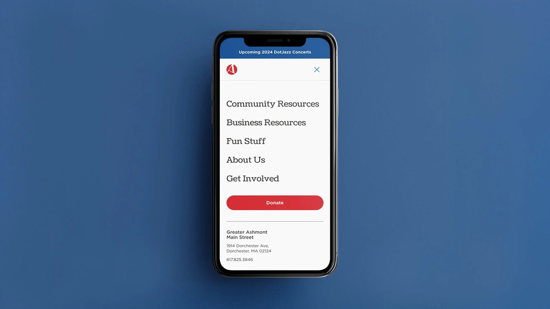 A smartphone screen displaying a community app with menu options such as Community Resources, Business Resources, Fun Stuff, About Us, and Get Involved, alongside a red 'Donate' button. Background is solid blue.