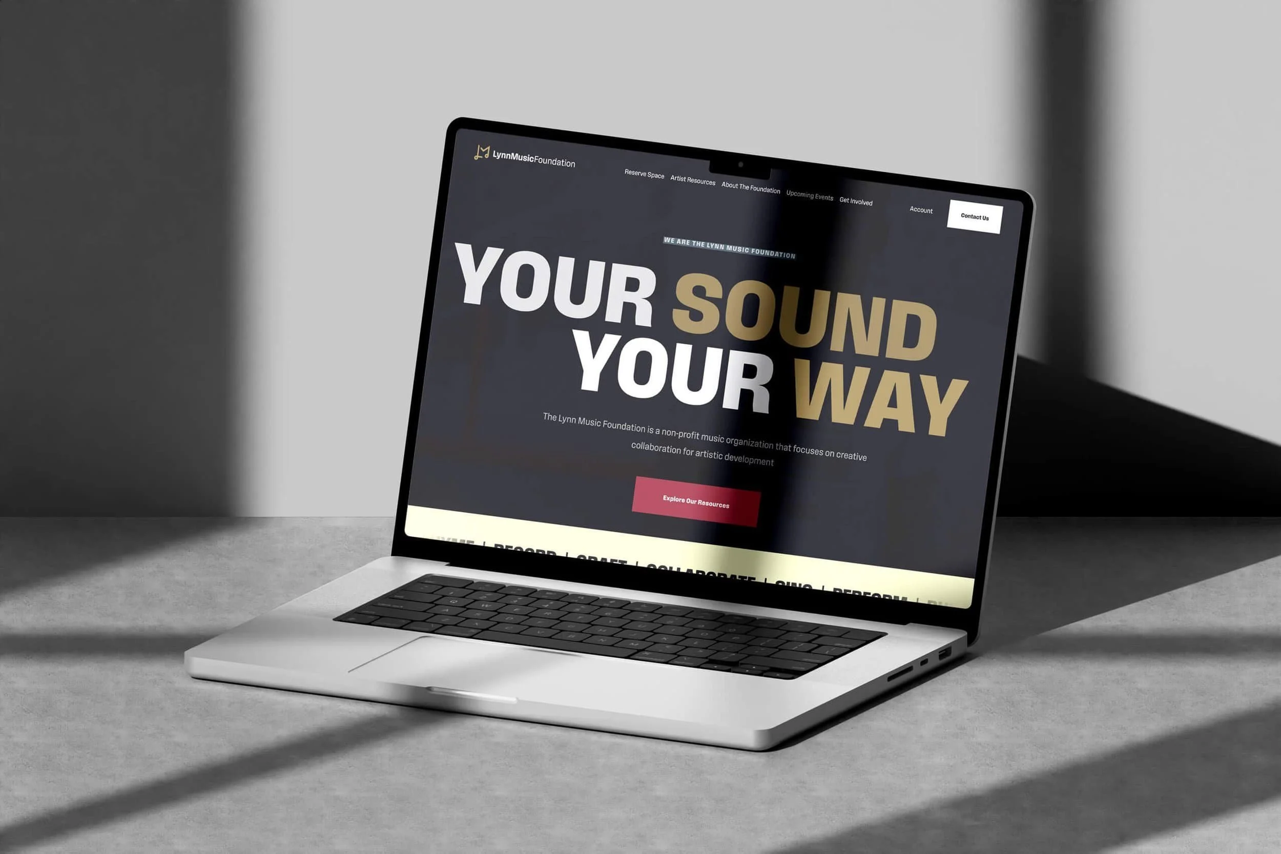 A laptop on a gray surface displays a nonprofit branding and website design page with the large text: YOUR SOUND YOUR WAY.
