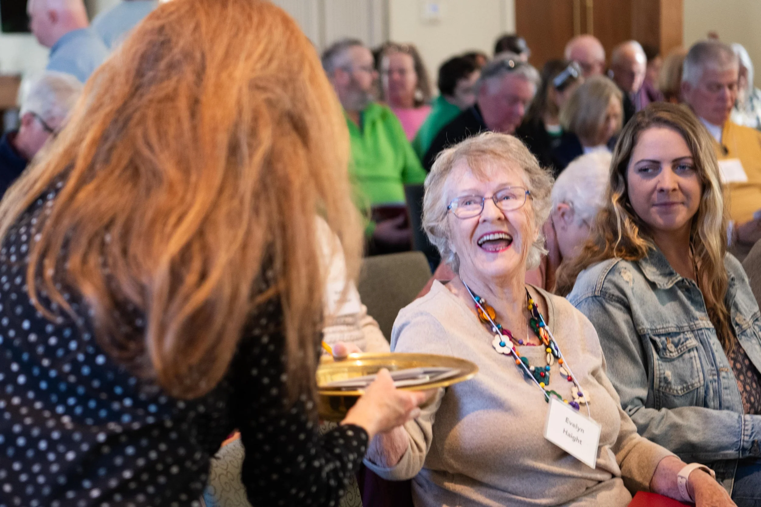 two people sitting around shelves of books