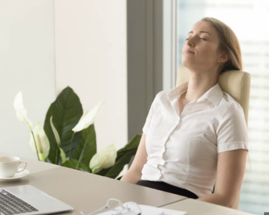 Illustration of a woman with orange hair, blue glasses, and a blue top exhaling a puff of air.