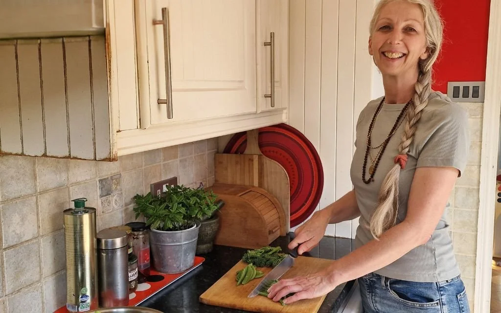 Katja Patel chopping vegetables in a home kitchen, showing a simple, everyday approach to Ayurvedic nourishment