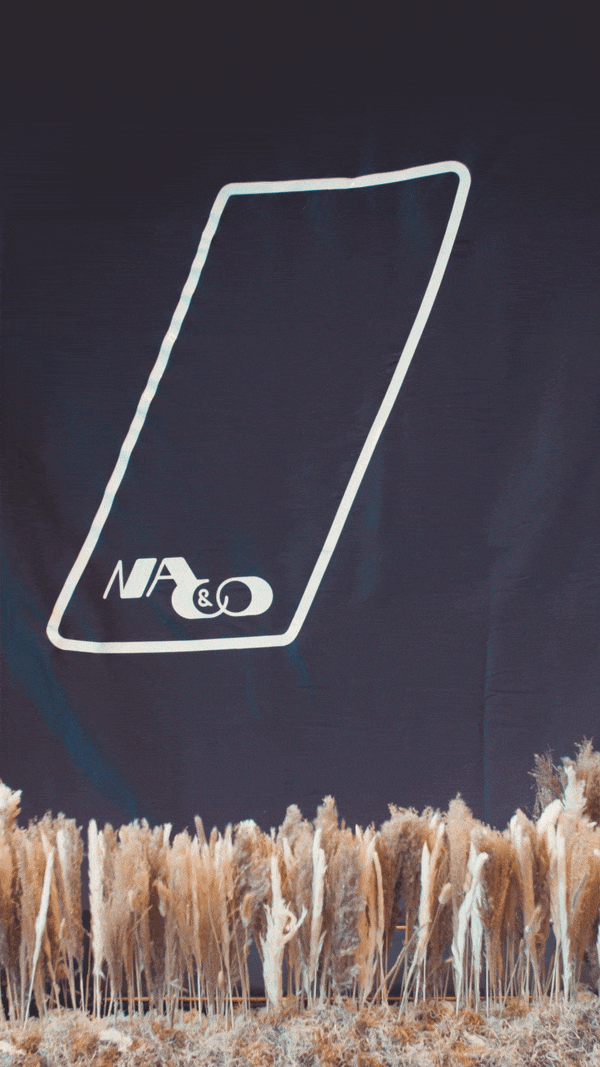 Decorative grass in front of navy banner with outlined shape and logo "NA&O".