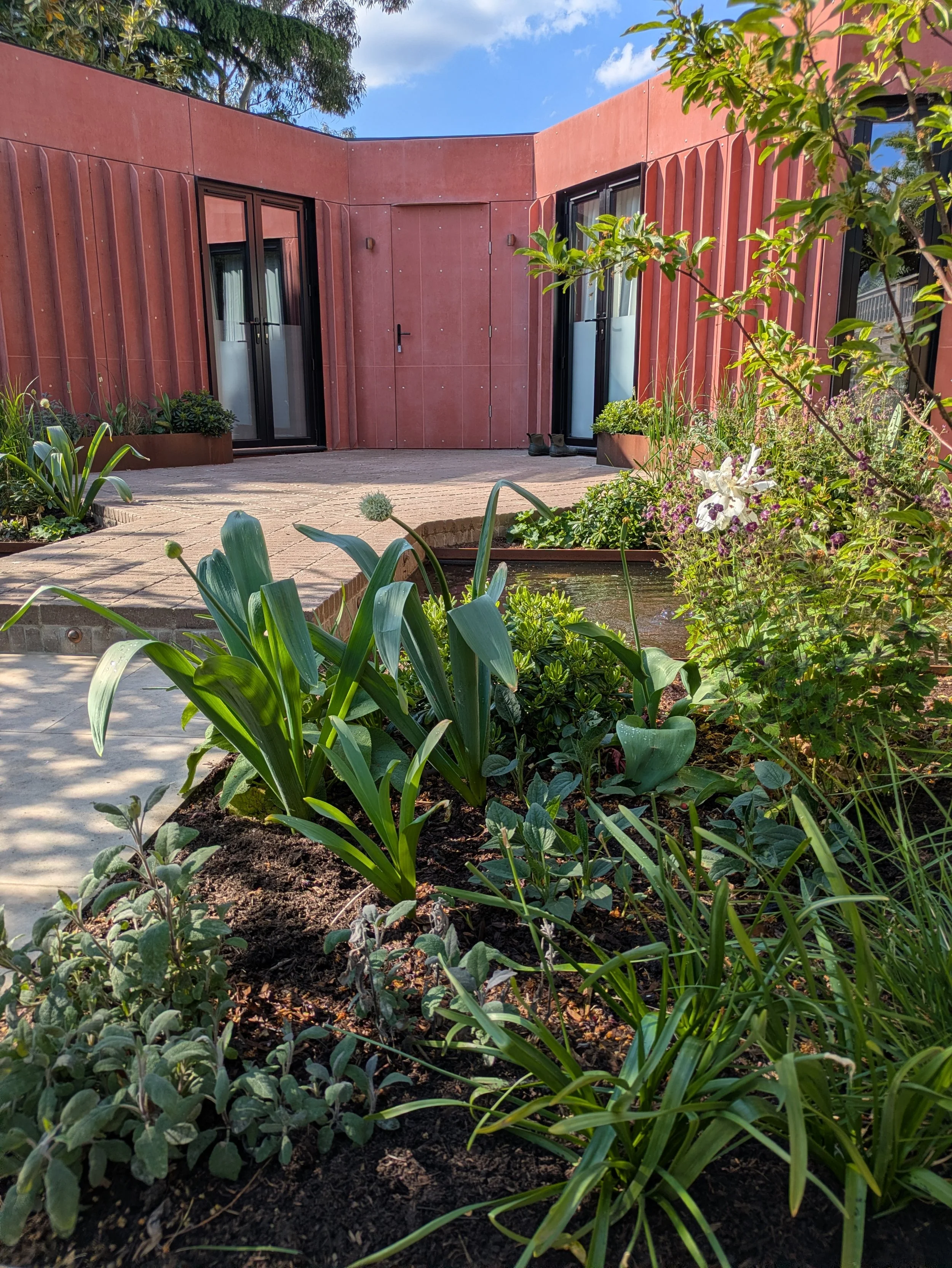 Architectural garden studio with pond