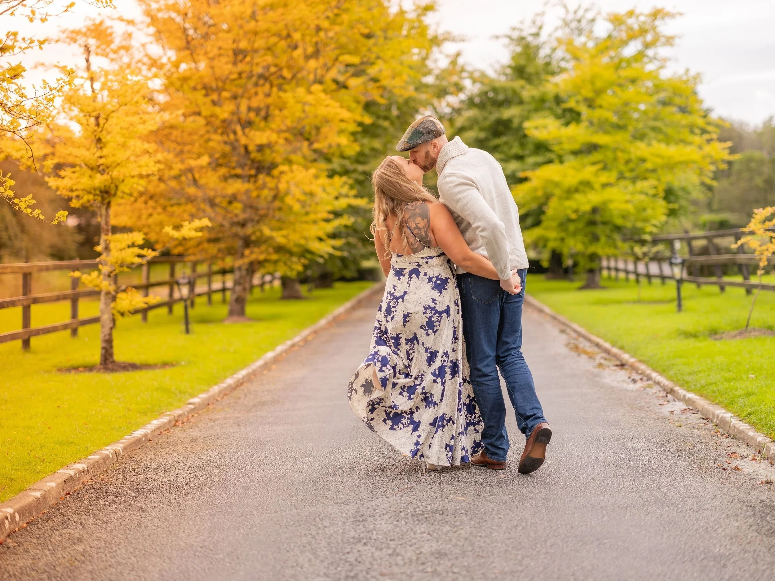 A couple sharing a kiss on a tree-lined path in autumn. Best-Fashion-Portrait-Commercial-Business-Headshots-Corporate- photography-Maryland-Washington D.C.-Pennsylvania-Virginia