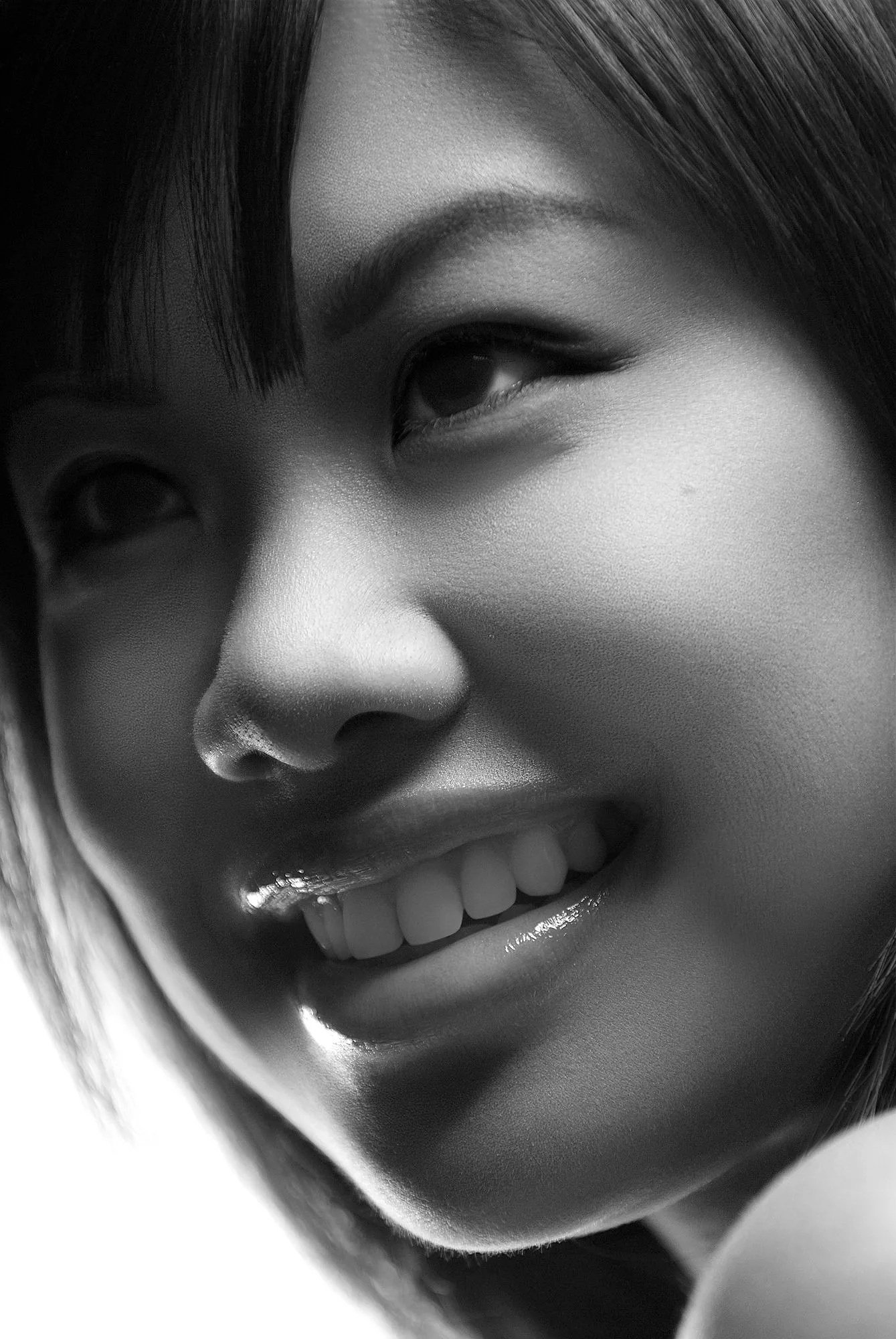 Close-up black-and-white photo of a smiling woman with short hair, focusing on her face, eye, nose, and teeth. Best-Fashion-Portrait-Commercial-Business-Headshots-Corporate- photography-Maryland-Washington D.C.-Pennsylvania-Virginia