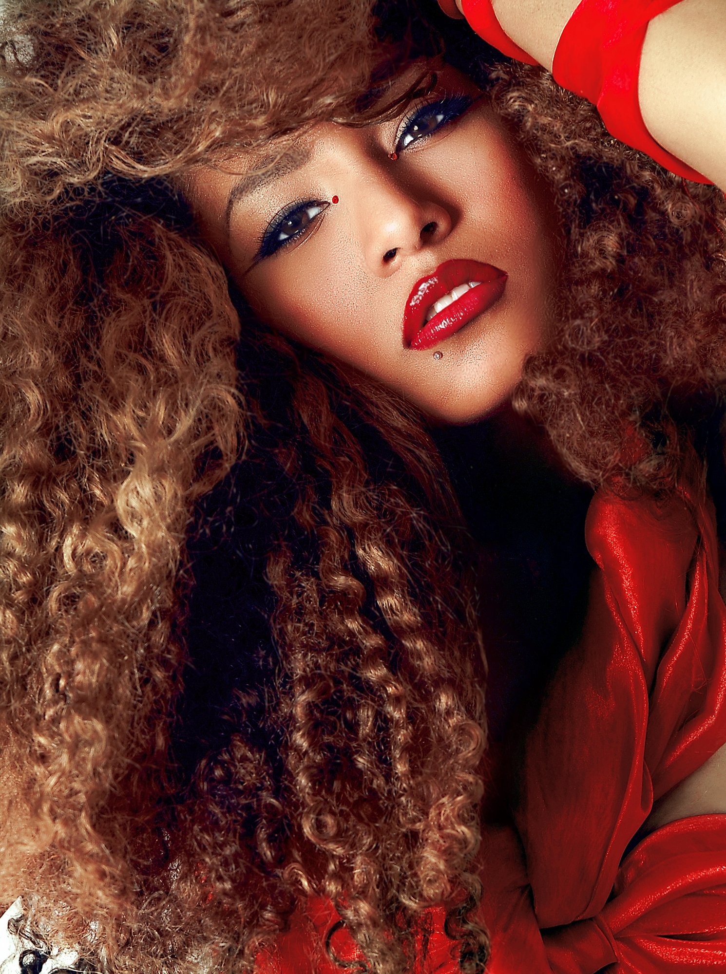 Close-up of a woman with curly red hair, blue eyes, bright red lipstick, and red clothing. Best-Fashion-Portrait-Commercial-Business-Headshots-Corporate- photography-Maryland-Washington D.C.-Pennsylvania-Virginia