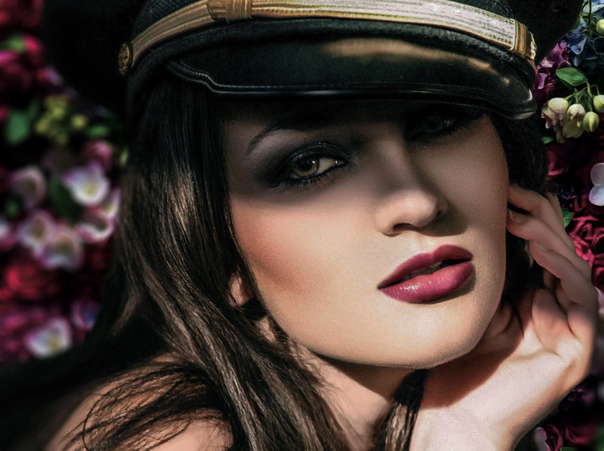 Close-up of a woman with dark hair, wearing a black leather hat, lying on pink and purple flowers, with her hand near her face, looking at the camera. Best-Fashion-Portrait-Commercial-Business-Headshots-Corporate- photography-Maryland-Washington D.C.