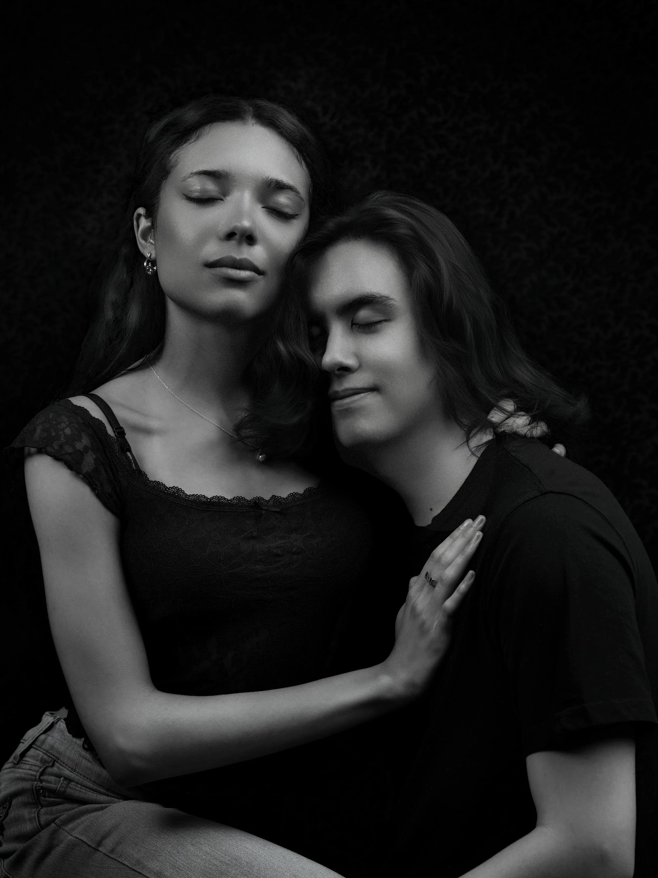 A black and white portrait of two people with their eyes closed, embracing each other and showing a sense of intimacy and calm. Best-Fashion-Portrait-Commercial-Business-Headshots-Corporate- photography-Maryland-Washington D.C.-Pennsylvania-Virginia