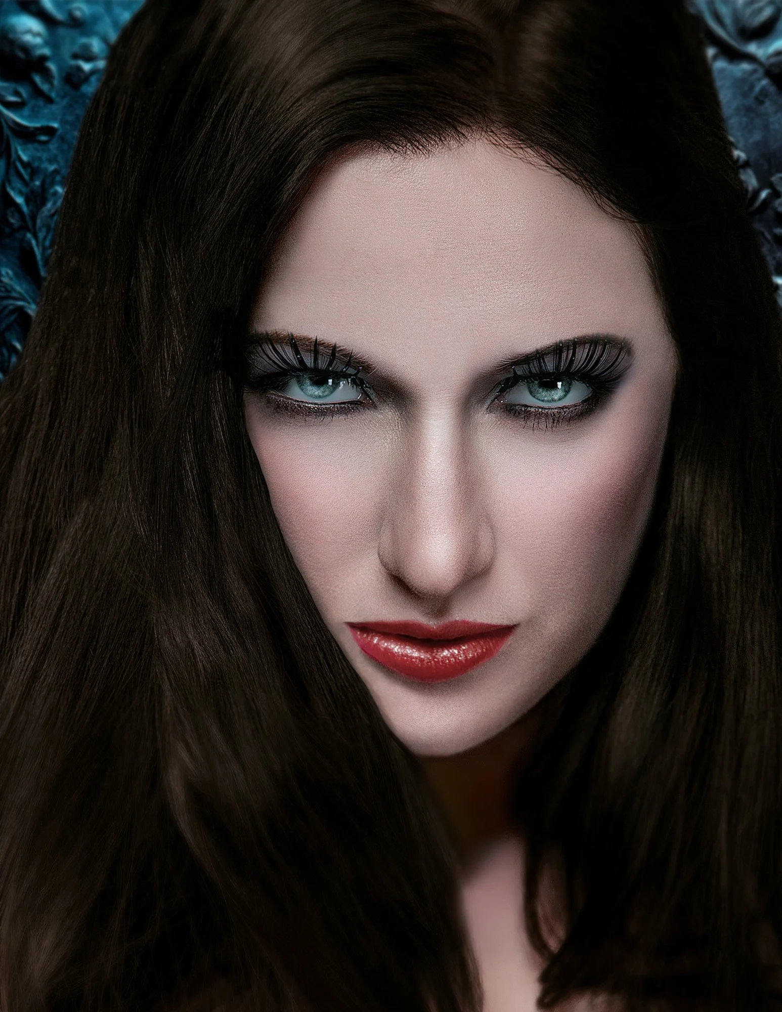 Close-up of a woman with striking blue eyes, dark eye makeup, long brown hair, and red lipstick, looking directly at the camera. Best-Fashion-Portrait-Commercial-Business-Headshots-Corporate- photography-Maryland-Washington D.C.-Pennsylvania-Virginia