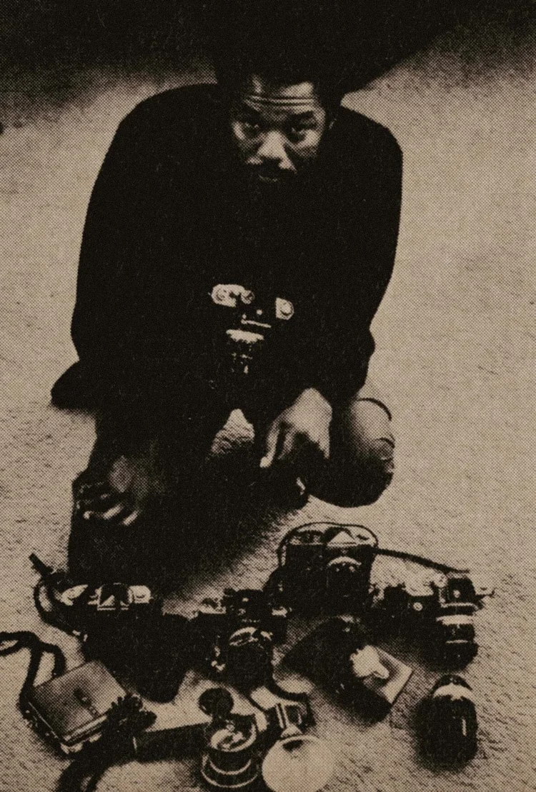Howard Bingham surrounded by photographic and electronic equipment.