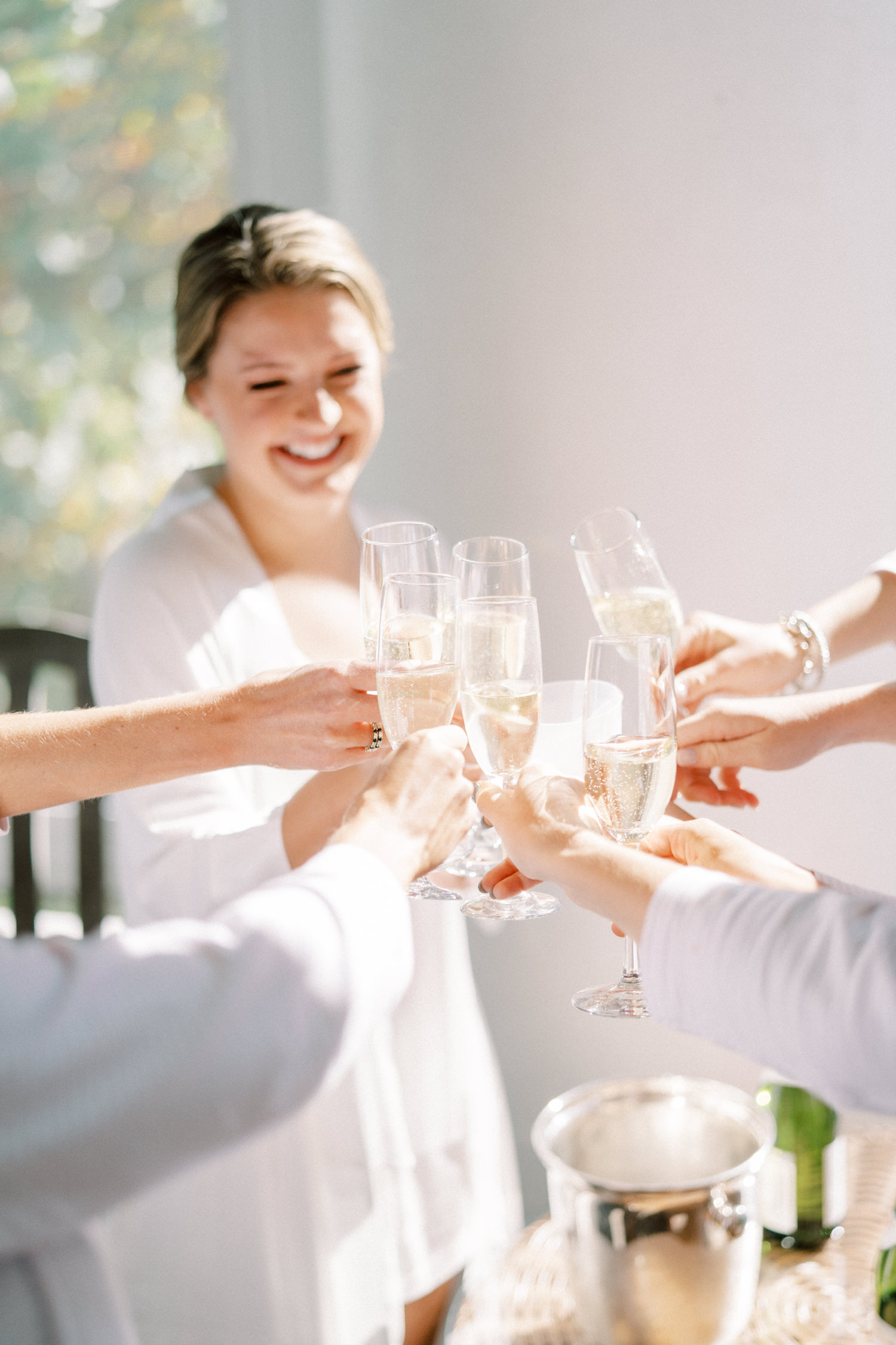 Bride toasts champagne with bridesmaids