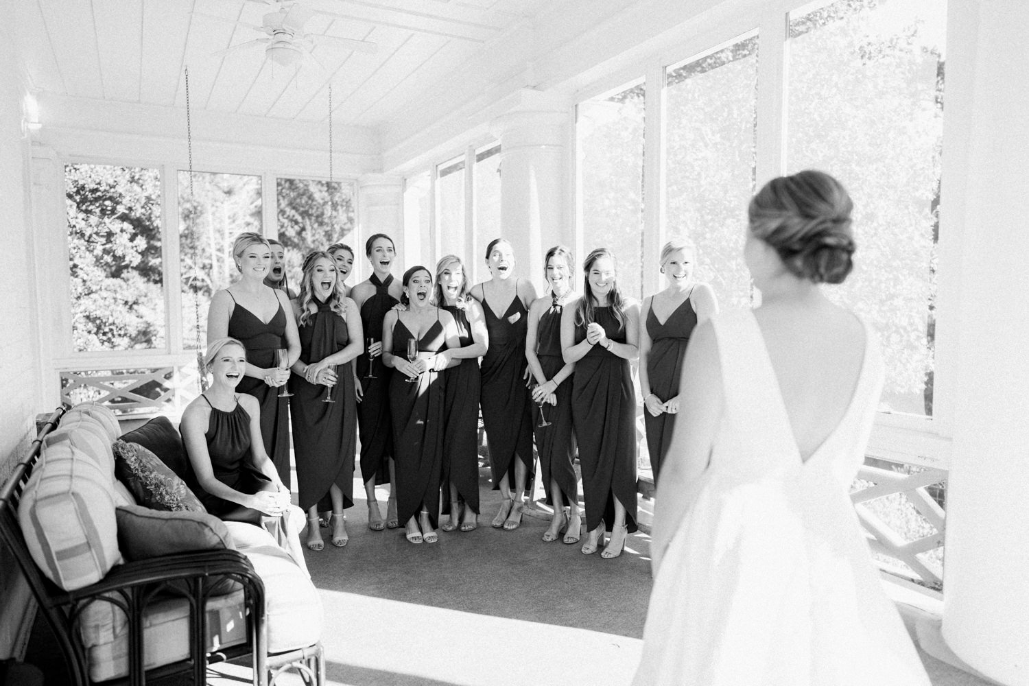 bride revealing her dress to bridesmaids