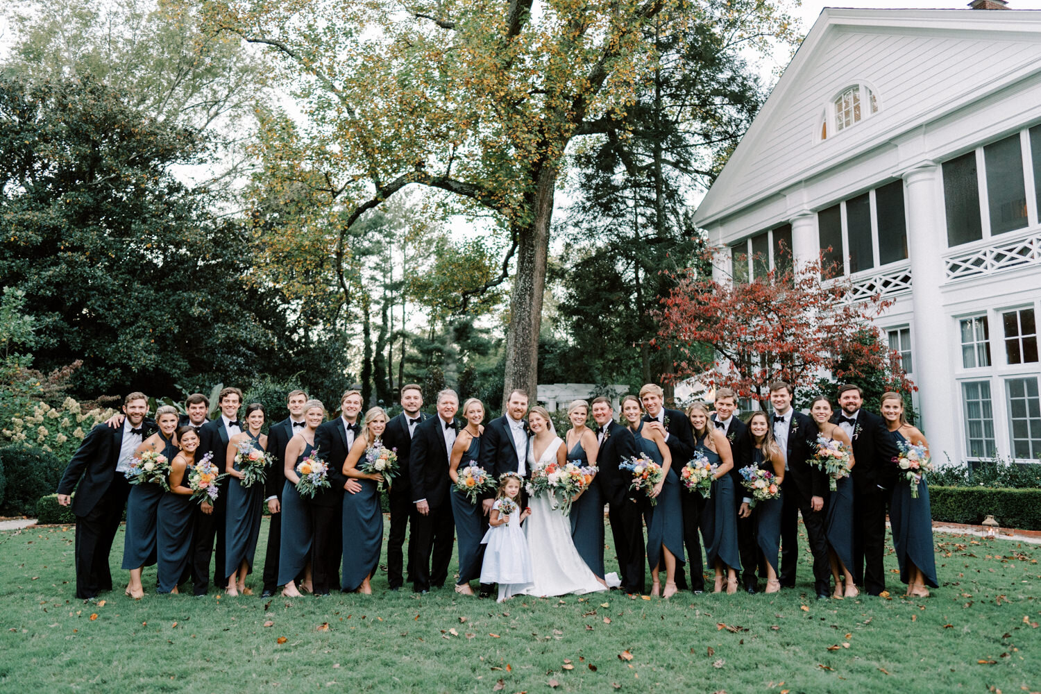 Bridal Party posing for a photo outside at Duke Mansion 