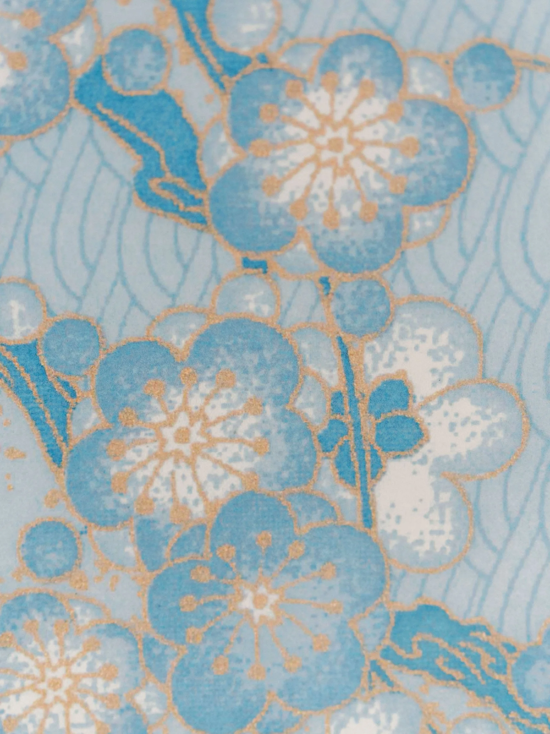 Close-up of a fabric with a floral pattern in blue and gold colors.