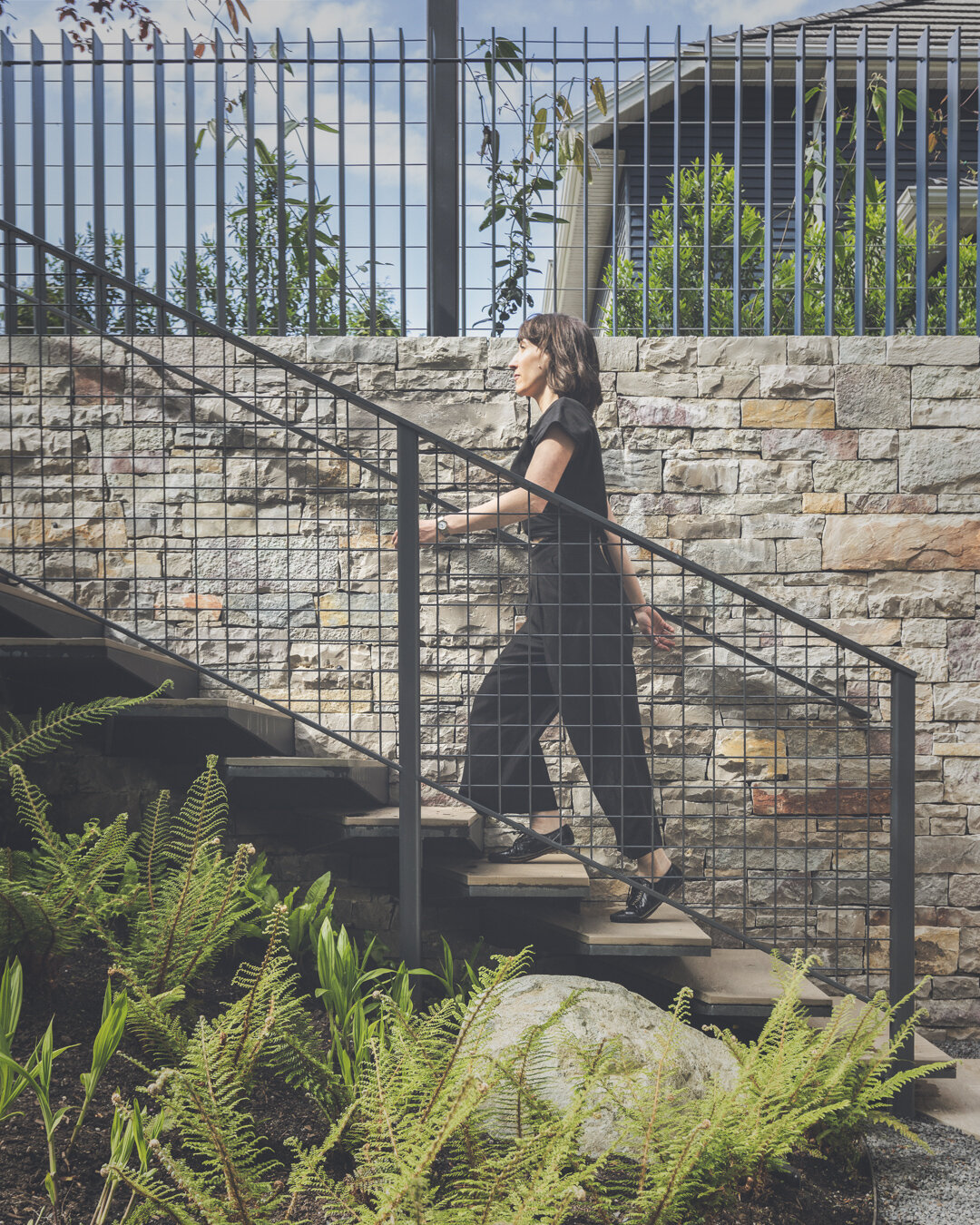 Our talented colleague and friend @randiwags modelling our custom trapezoidal aluminum floating steps in the sunken garden of this project. The steps are anchored to the wall and the treads are finished with a stone slab to match the rest of the ston