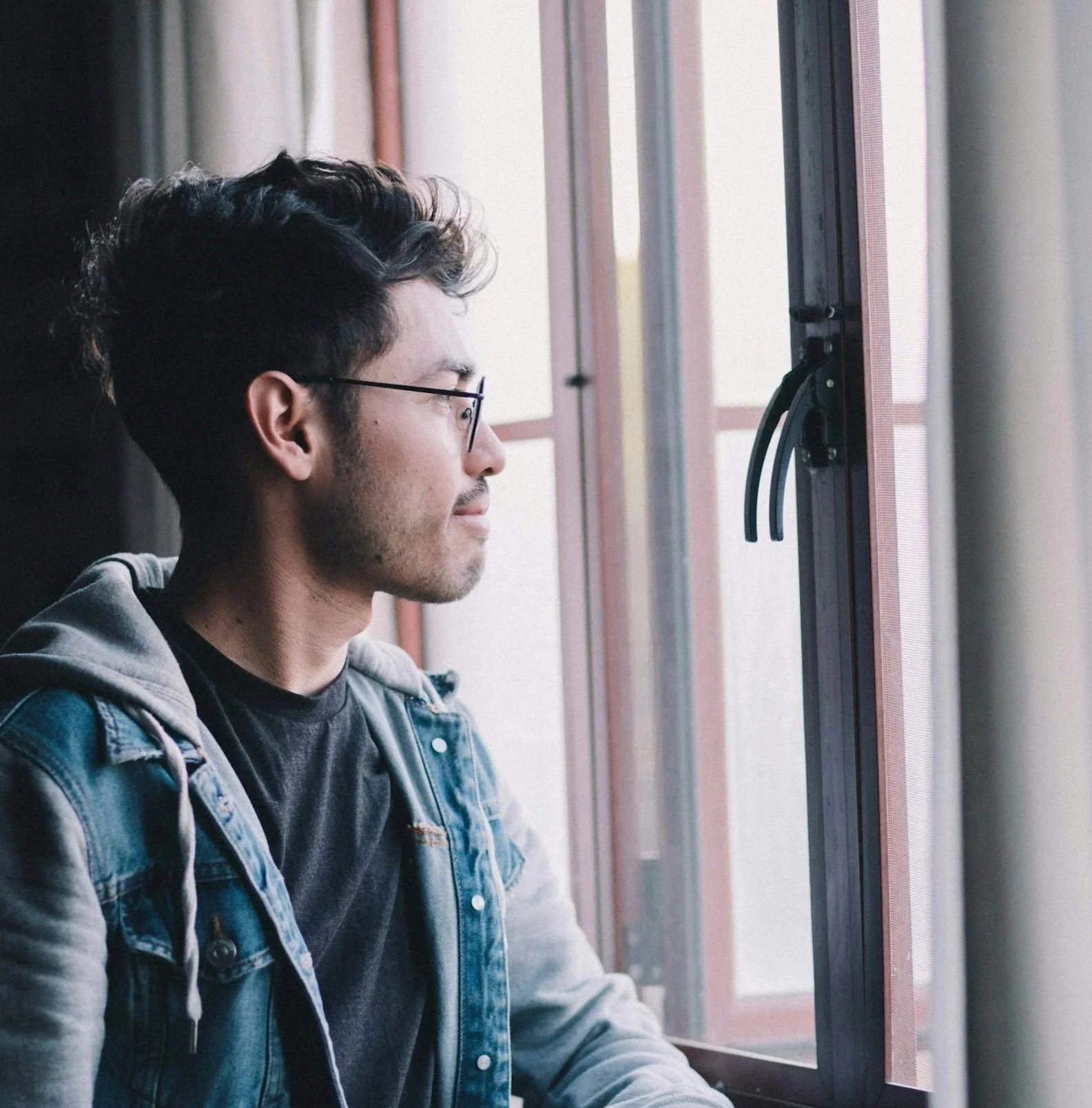 Man looking out window